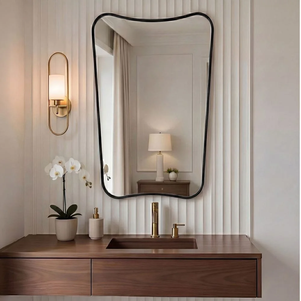 This vanity mirror features a sophisticated iron frame finished in a sleek satin black, surrounding a floating polished-edge mirror. 