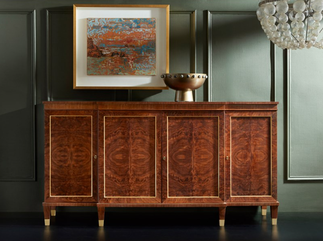 Walnut breakfront cabinet in feathered walnut veneer, with a painting hanging above.