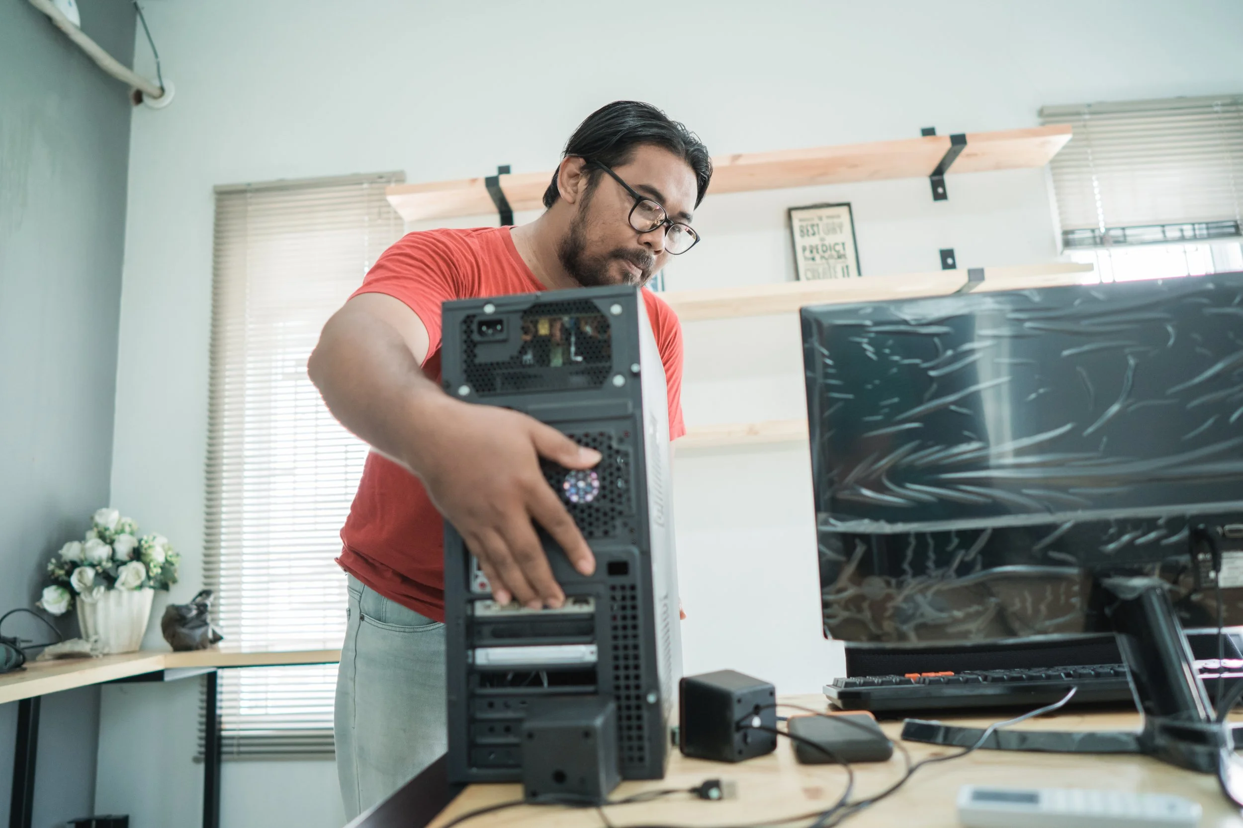 Technician repairing a desktop computer for a customer