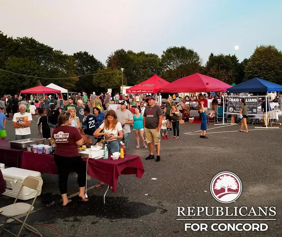 Outdoor event with people gathered around food tables and tents, under evening sky with visible moon, in a parking lot. Logo at bottom right reads "REPUBLICANS FOR CONCORD."