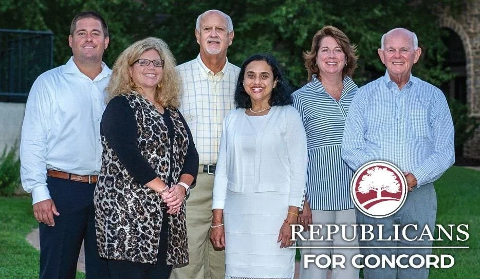 Six people standing outdoors in front of greenery, smiling at the camera, with a logo and text reading 'Republicans for Concord' at the bottom.