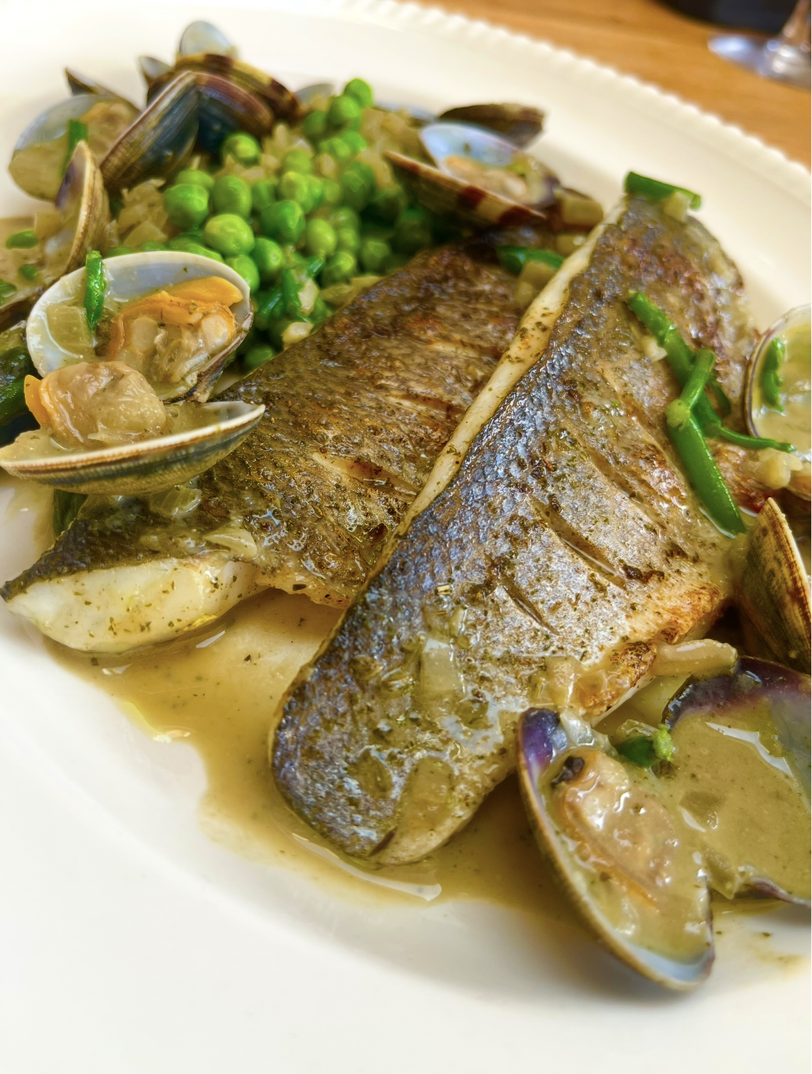 Grilled Sea Bass fillets, steamed clams, garlic & herb butter 03/06
