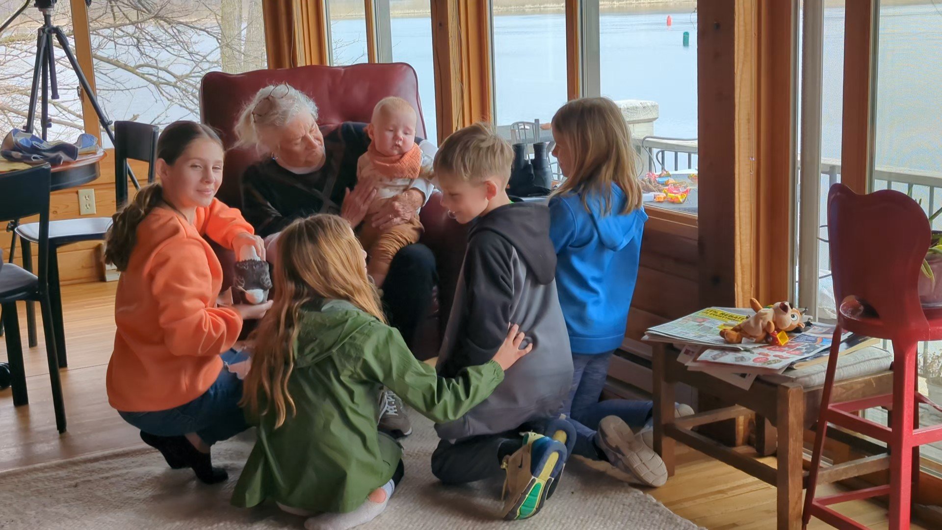 At the family cabin with Great Auntie reading to some of the cousins. 