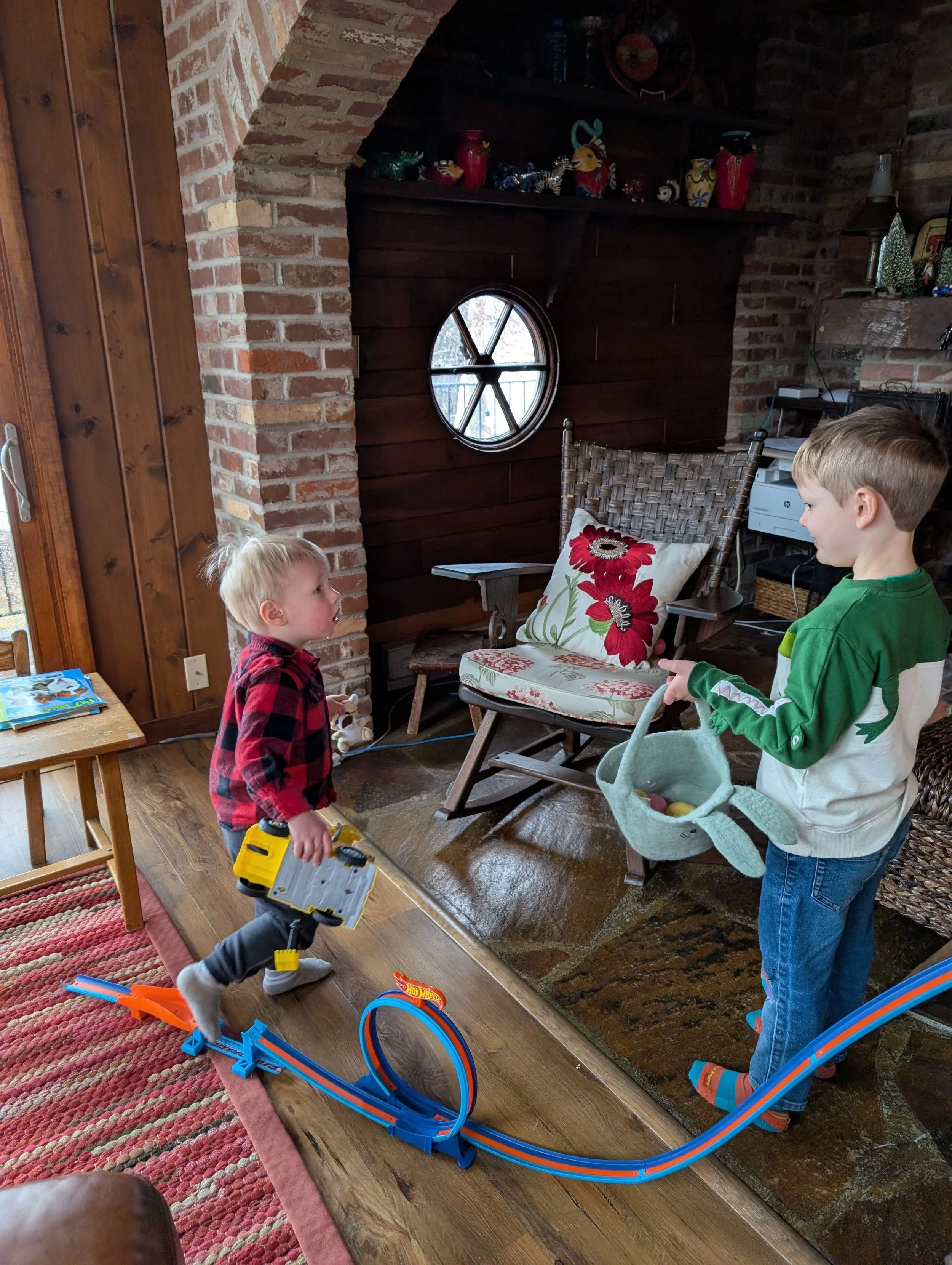 Older cousin teaching Matthew about Easter Egg hunts.