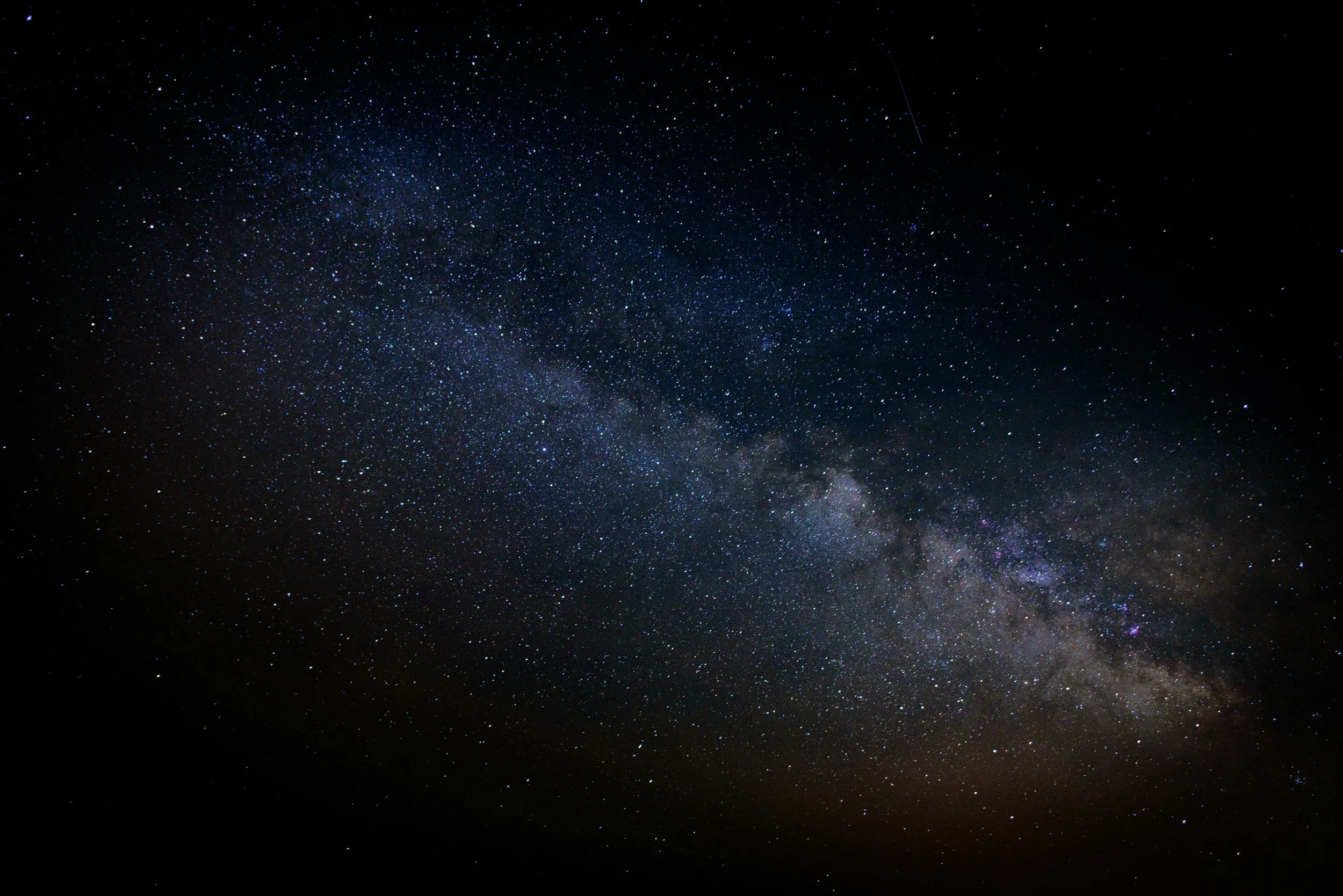 Night sky with stars and the Milky Way galaxy visible.