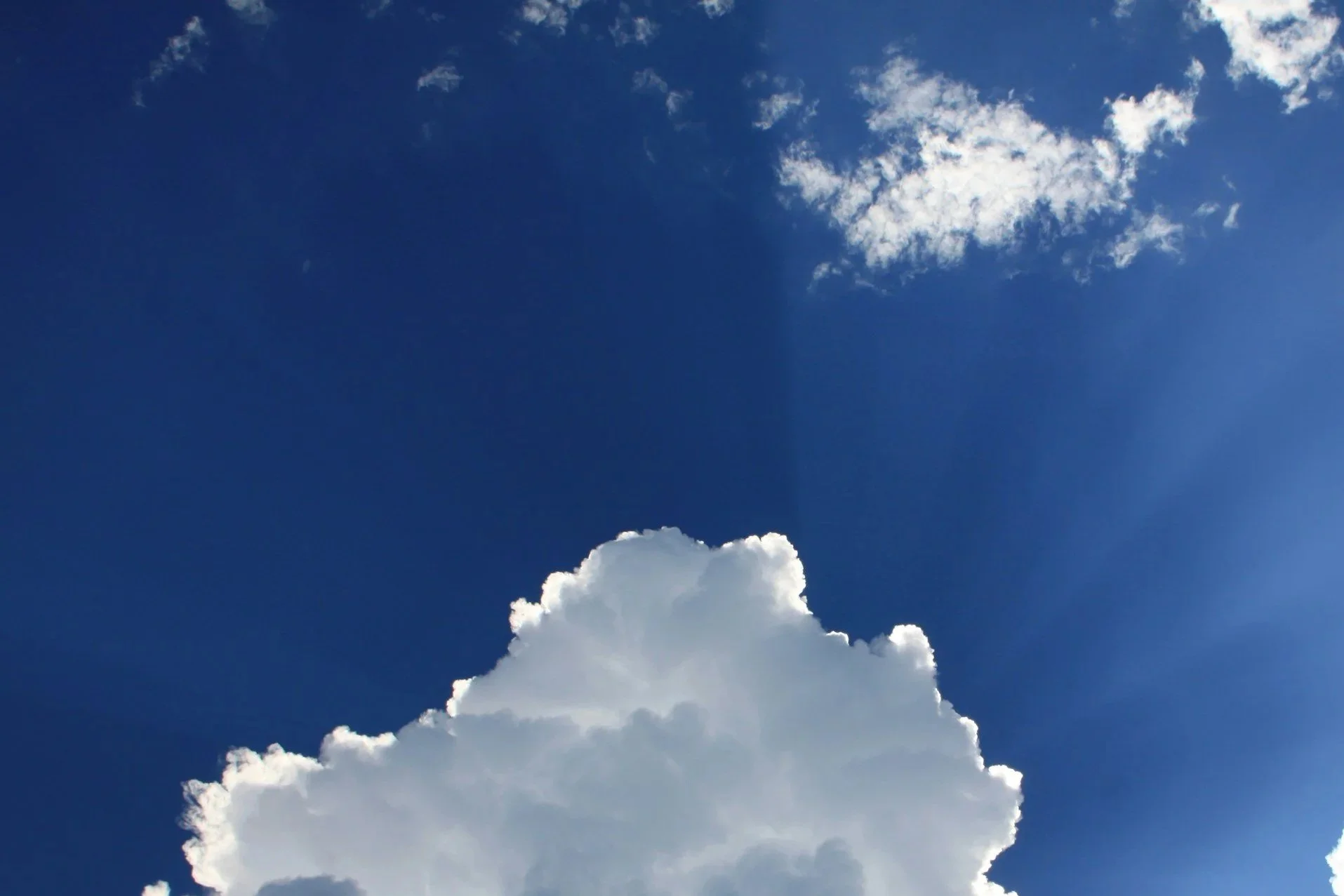 Clear blue sky with a large white cloud and a small wispy cloud.