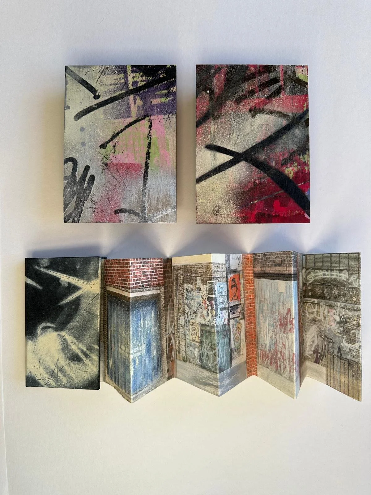 Graffiti:
Concertina book with spraypainted wooden box.
1/1
Box dimensions: 10.5cm x 14.5cm x 3.5cm.
Book dimensions: 7.5cm x 10.5cm x 60cm.