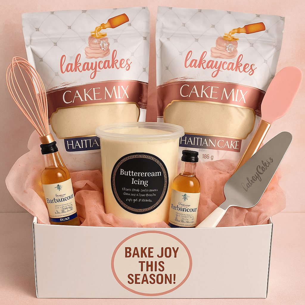 A gift box contains two packets of cake mix, a jar of buttercream icing, mini bottles of butter flavoring, pink and gray spatulas, and a pink whisk, with a note saying "Bake joy this season!"