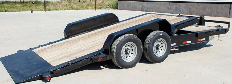 20-foot tilt deck equipment trailer with dual axle wheels and wood deck for loading machinery, available for rent at McKinleyville Ace Home & Garden Center.