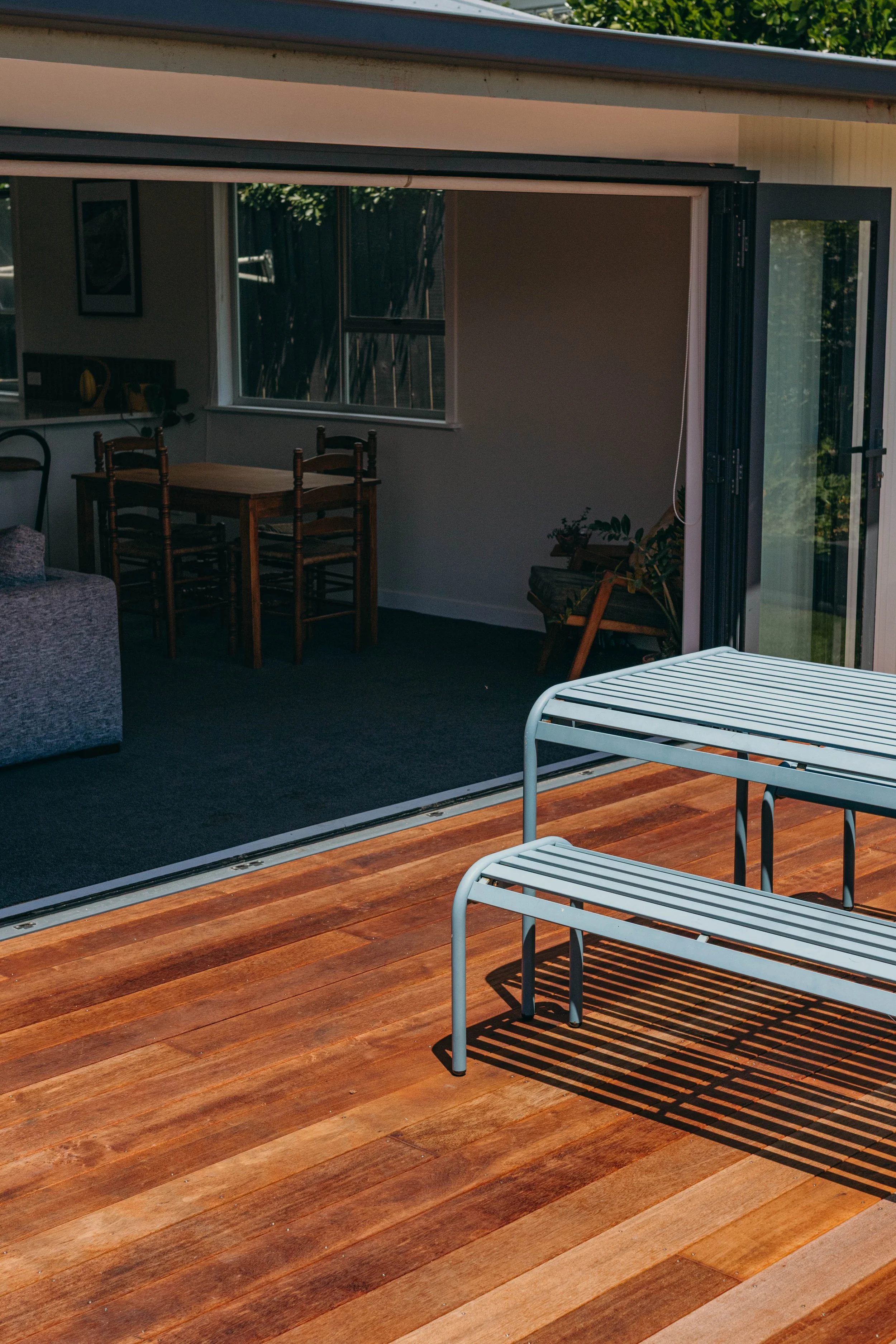 Indoor outdoor coastal living with an outdoor table on a deck