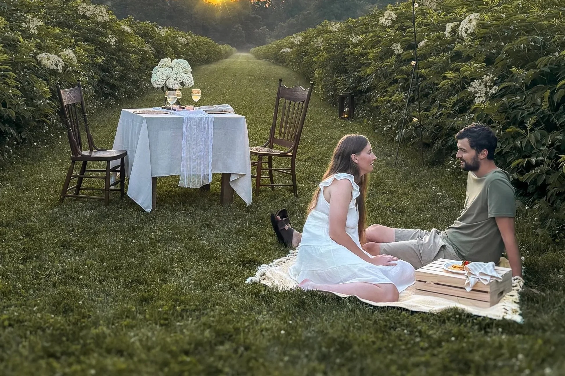 Couple enjoying an elderflower picnic