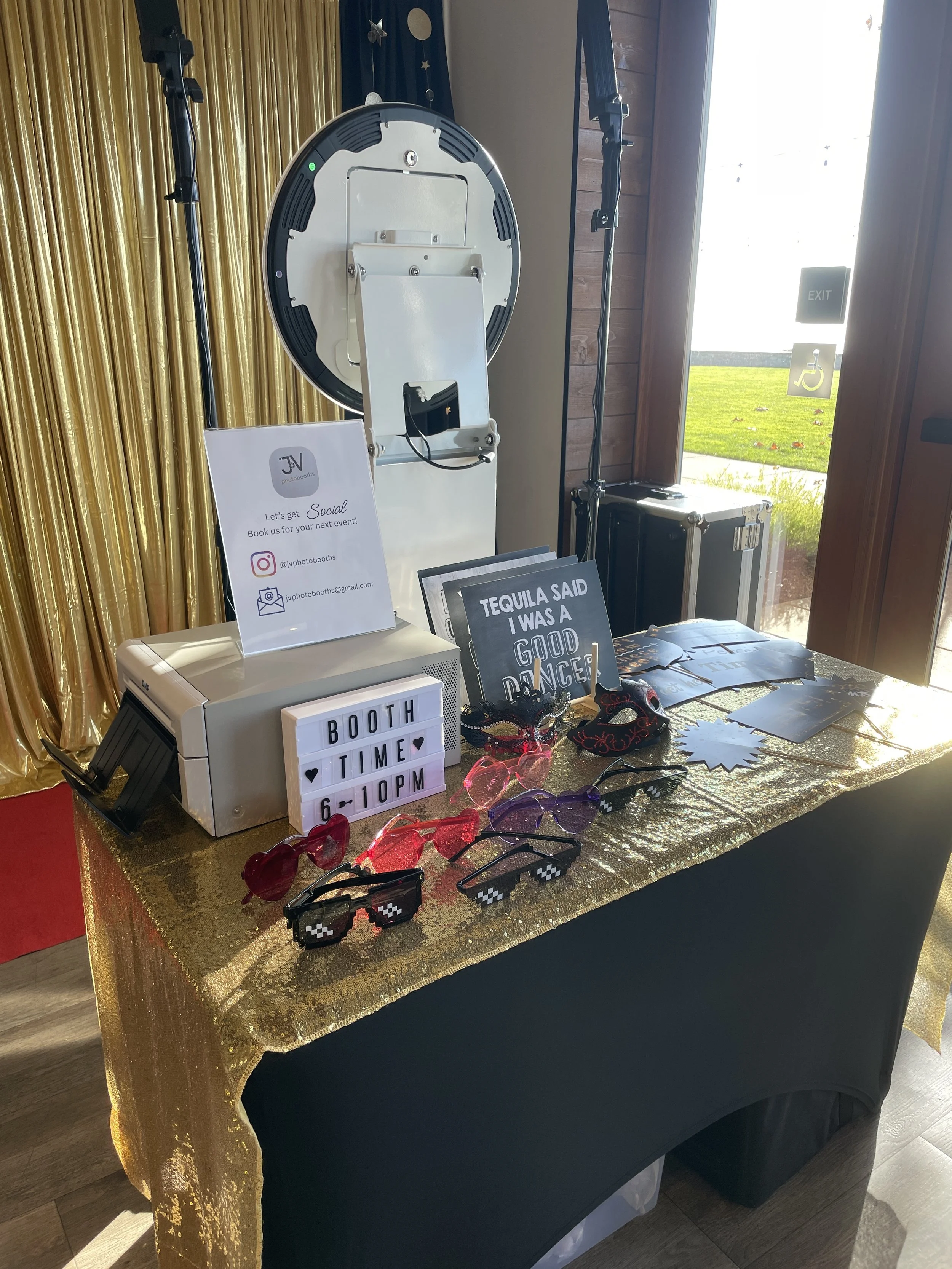 Photo of a photo booth setup at an event with curate props, custom backdrop, red carpet elevating your next event.