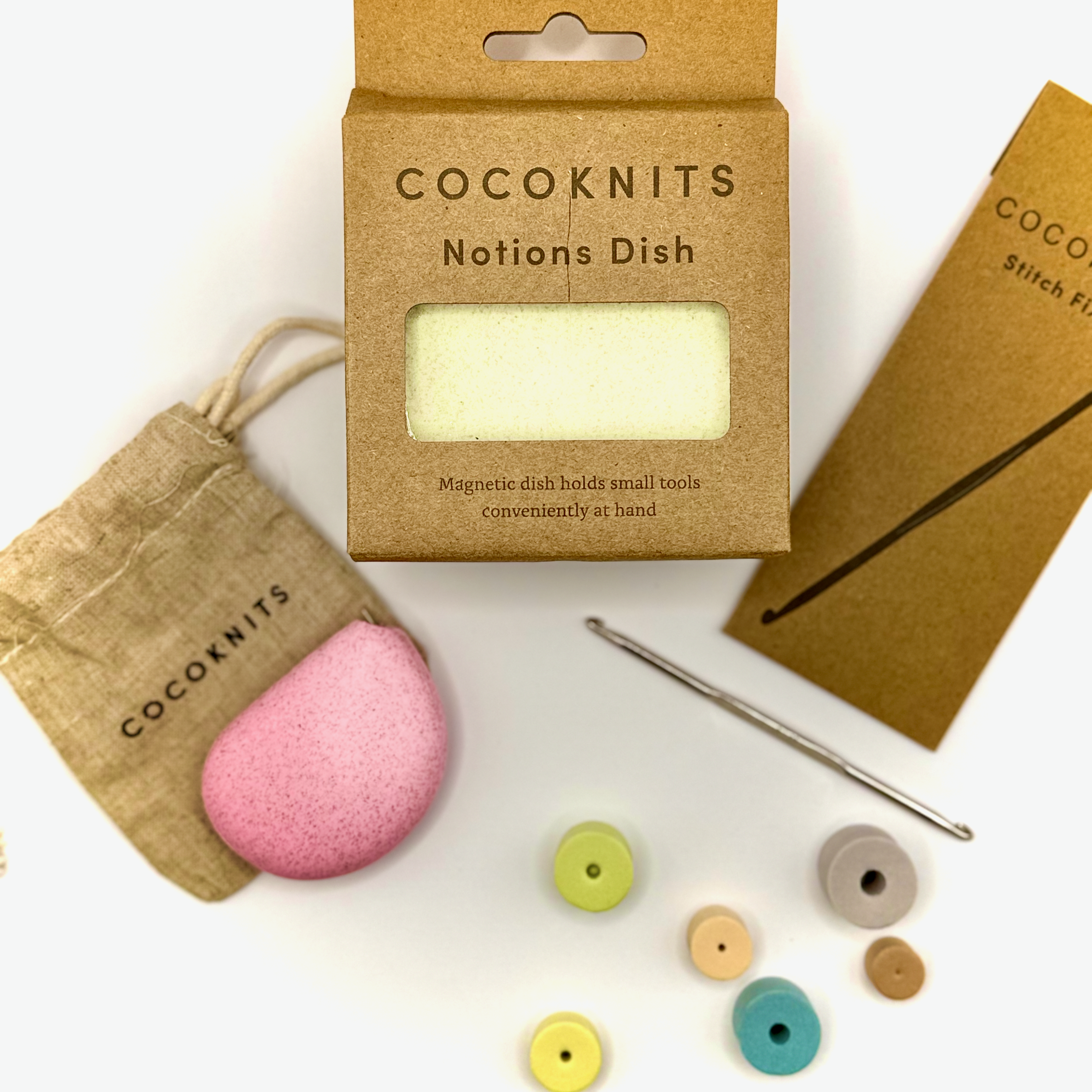 Knitting crocheting and craft maker notions labeled 'Cocoknits' containing small tools displayed.