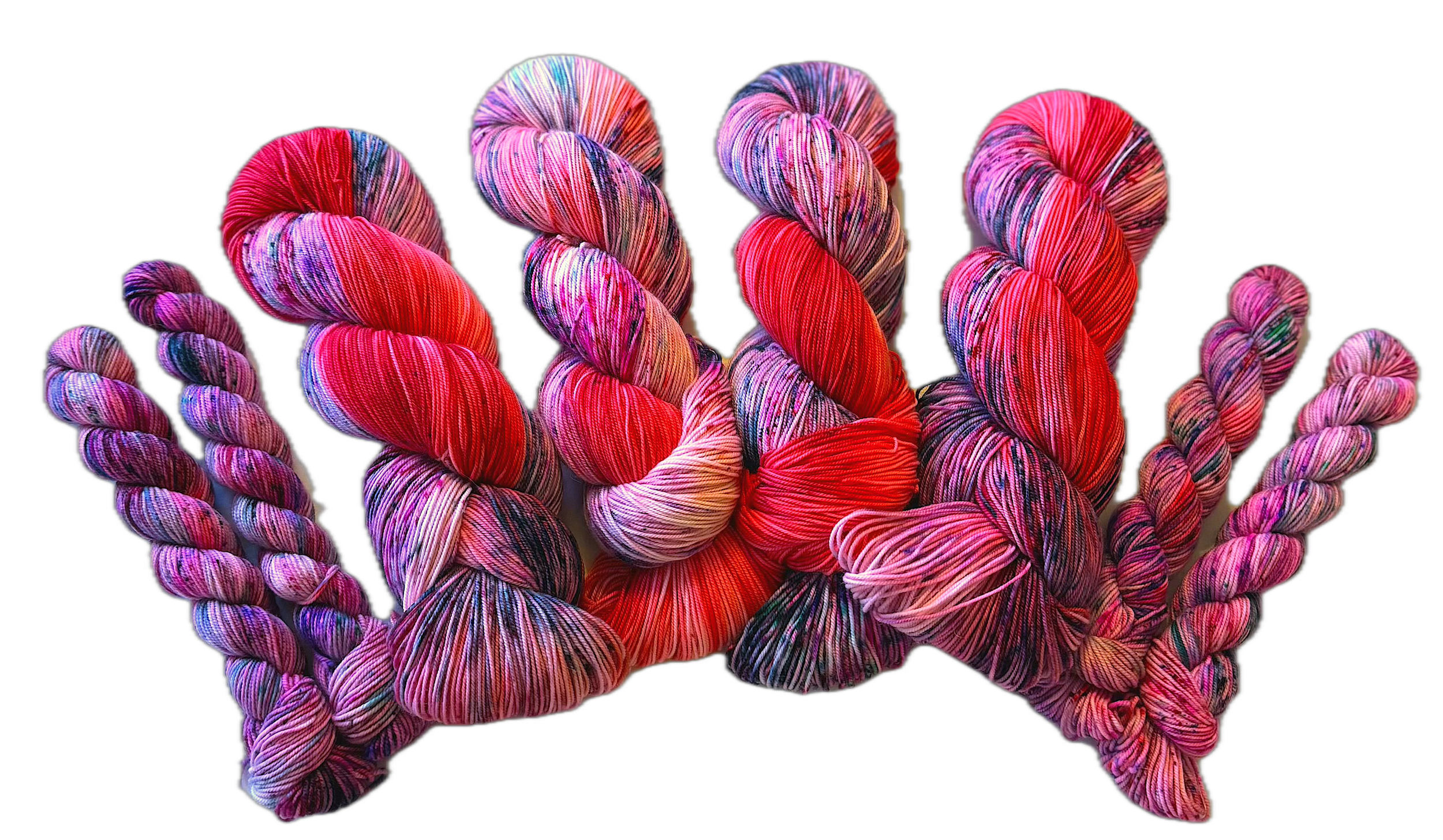 Colorful skeins of yarn hand dyed in various shades of pink, red, purple, and multicolor against a white background.