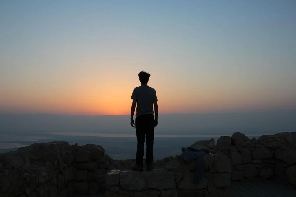 silhouette-of-person-standing-amongst-ruins-at-sunrise-gazing-out..jpg