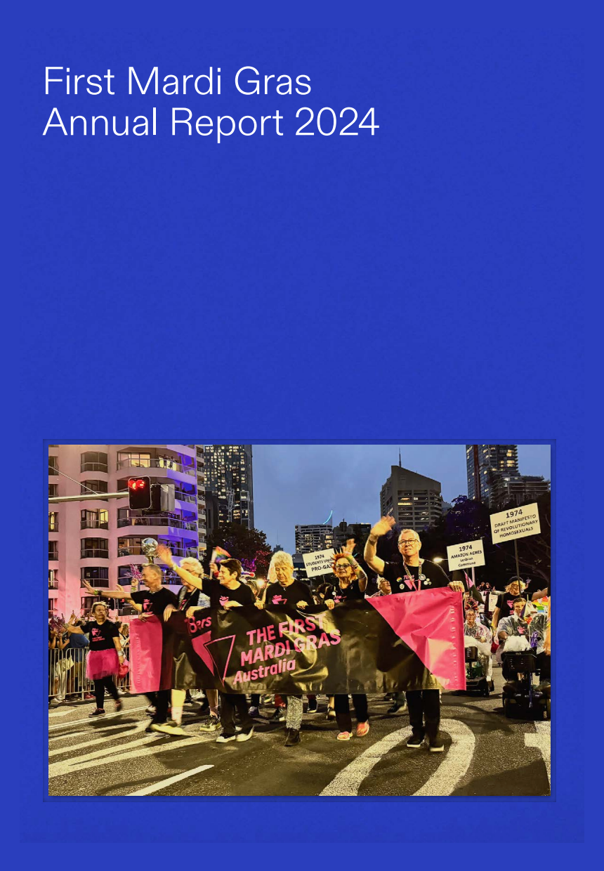 A group of people marching in a pride parade holding a banner that reads 'The First Mardi Gras Australia' with city buildings in the background at night.