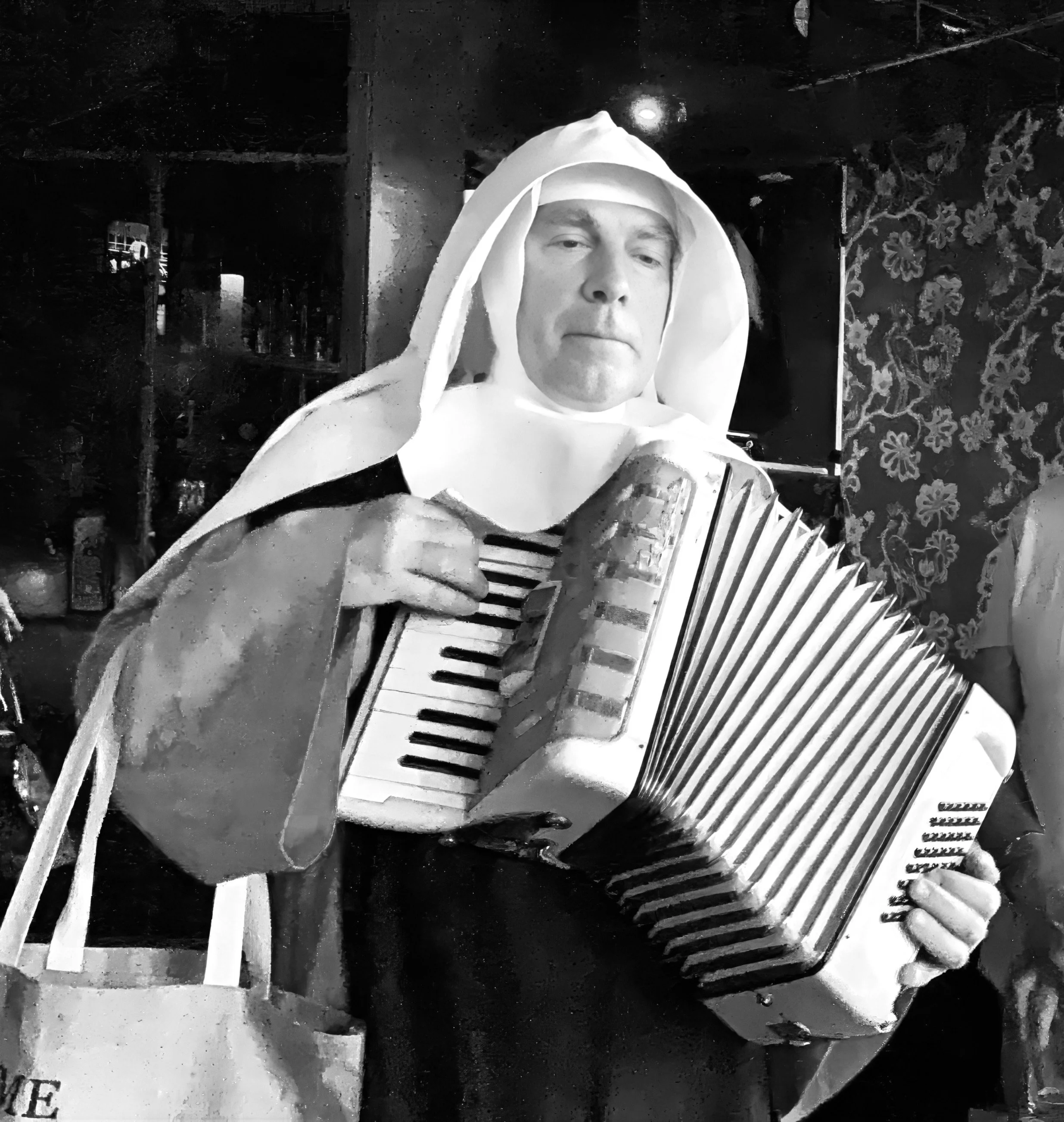 Black and white photo of a person in medieval-style clothing, including a hood, holding a guitar and a fan.