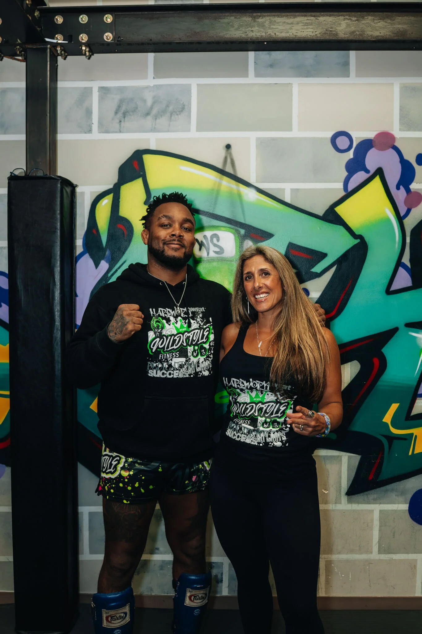 WildStyle Gym founders and coaches Jason and Sara stand together inside the gym, highlighting the balance of martial arts expertise and fitness coaching that defines the WildStyle training system in Snohomish, Washington.