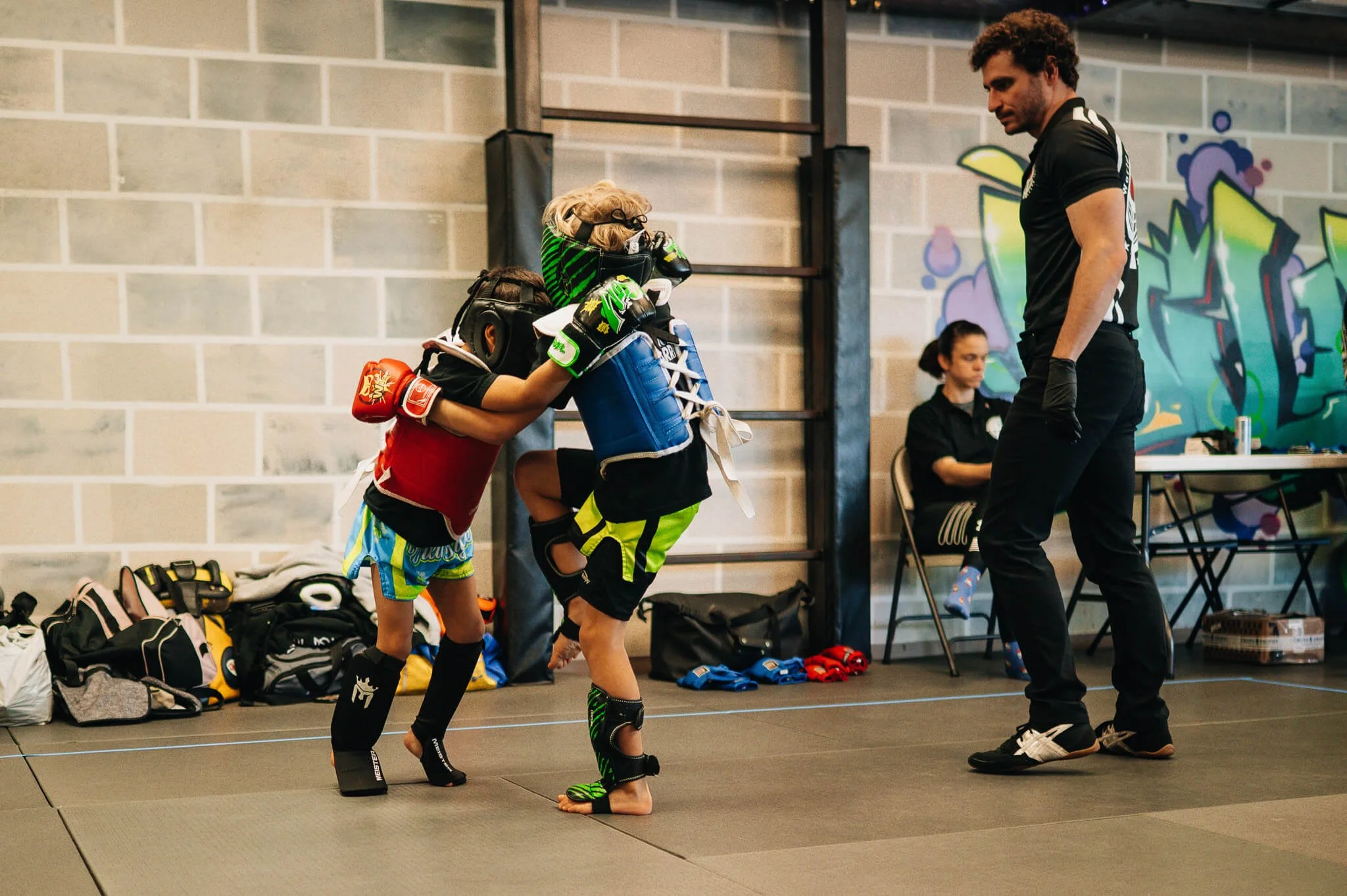 Youth kickboxing athletes participating in a supervised scrimmage at WildStyle Gym, building confidence, control, and real-world striking skills in a safe, structured training environment.