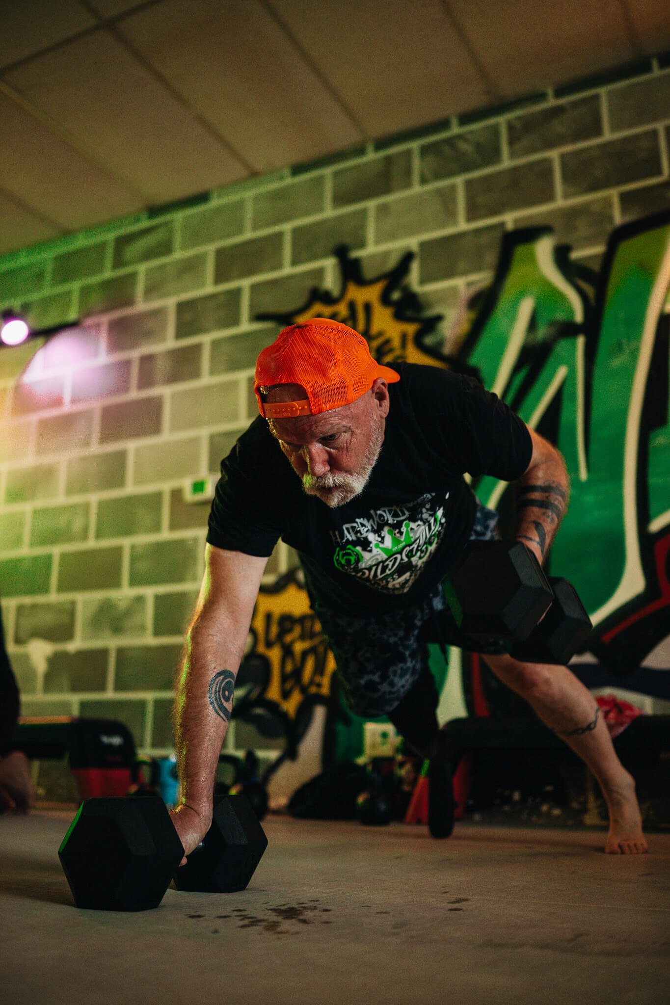 A WildStyle Gym member performs a functional dumbbell strength exercise during Champion Strength small group training in Snohomish, Washington, building real-world strength, stability, and athletic performance.