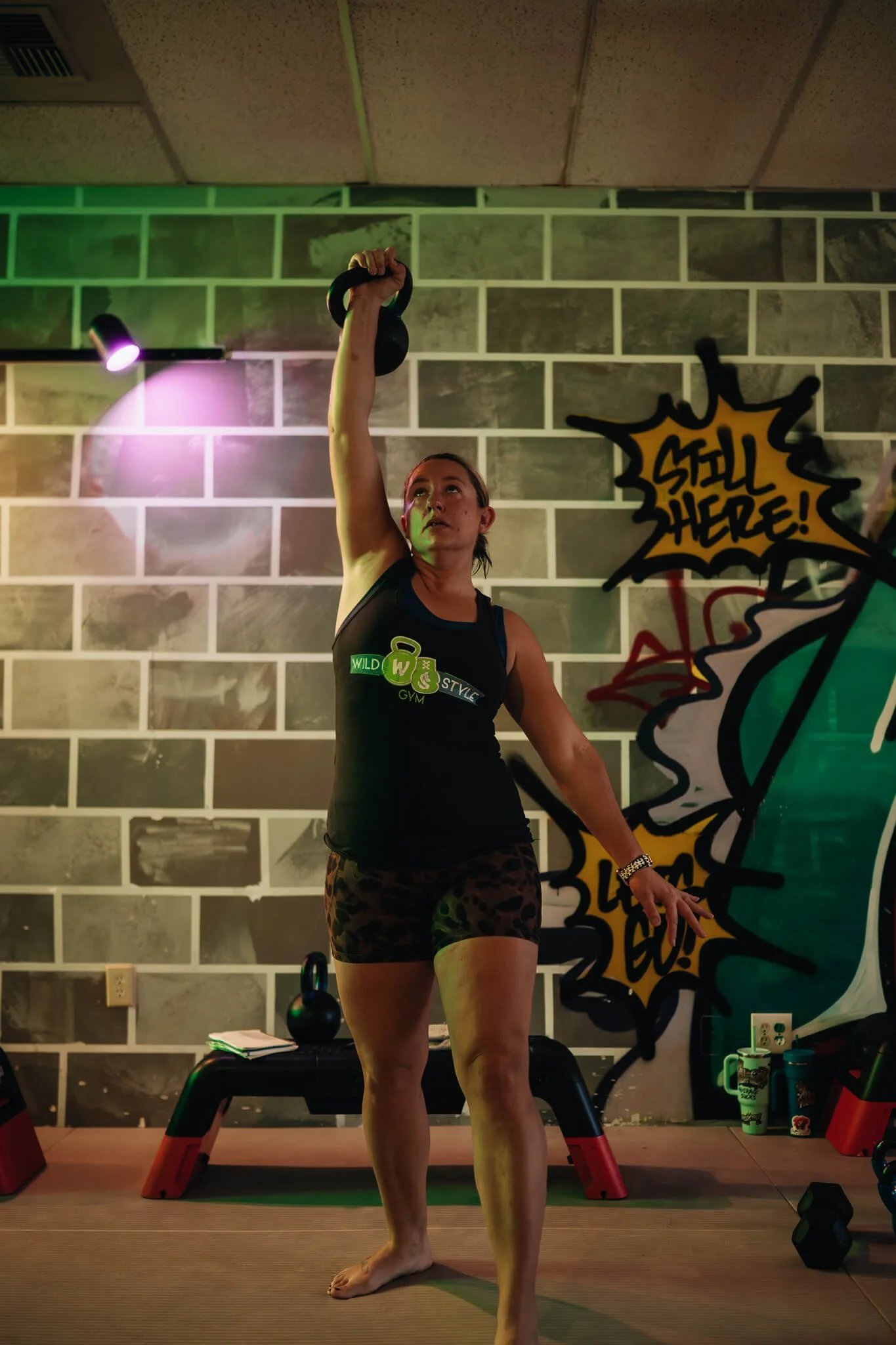 A WildStyle Gym member performs a kettlebell overhead lift during Champion Strength small group training in Snohomish, Washington, developing full-body strength, balance, and functional athletic ability.