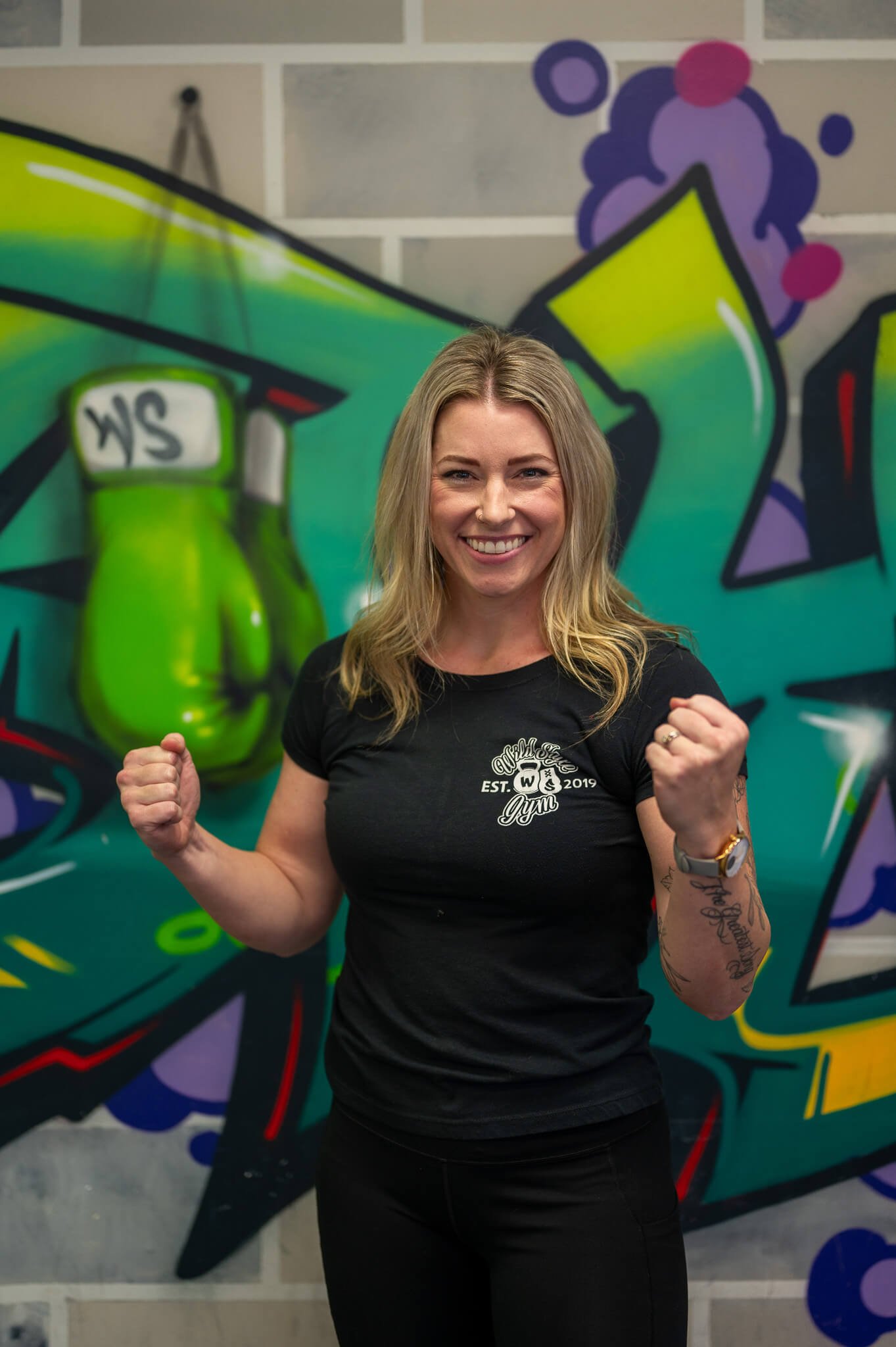 Coach Marilee celebrating strength and progress at WildStyle Gym in Snohomish, WA, reflecting the gym’s positive training culture.