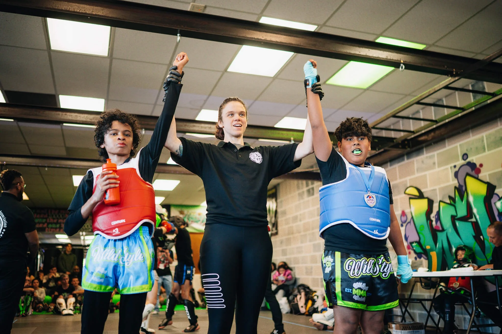 Youth kickboxing competitors celebrate after a WildStyle WKA scrimmage league match at WildStyle Gym in Snohomish, Washington