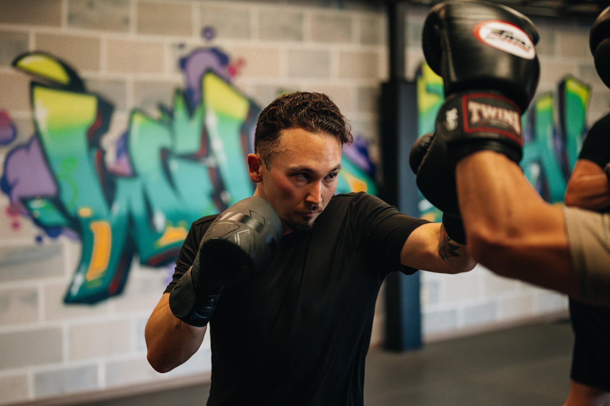 Adult kickboxing training at WildStyle Gym practicing striking technique and pad work in Snohomish, Washington