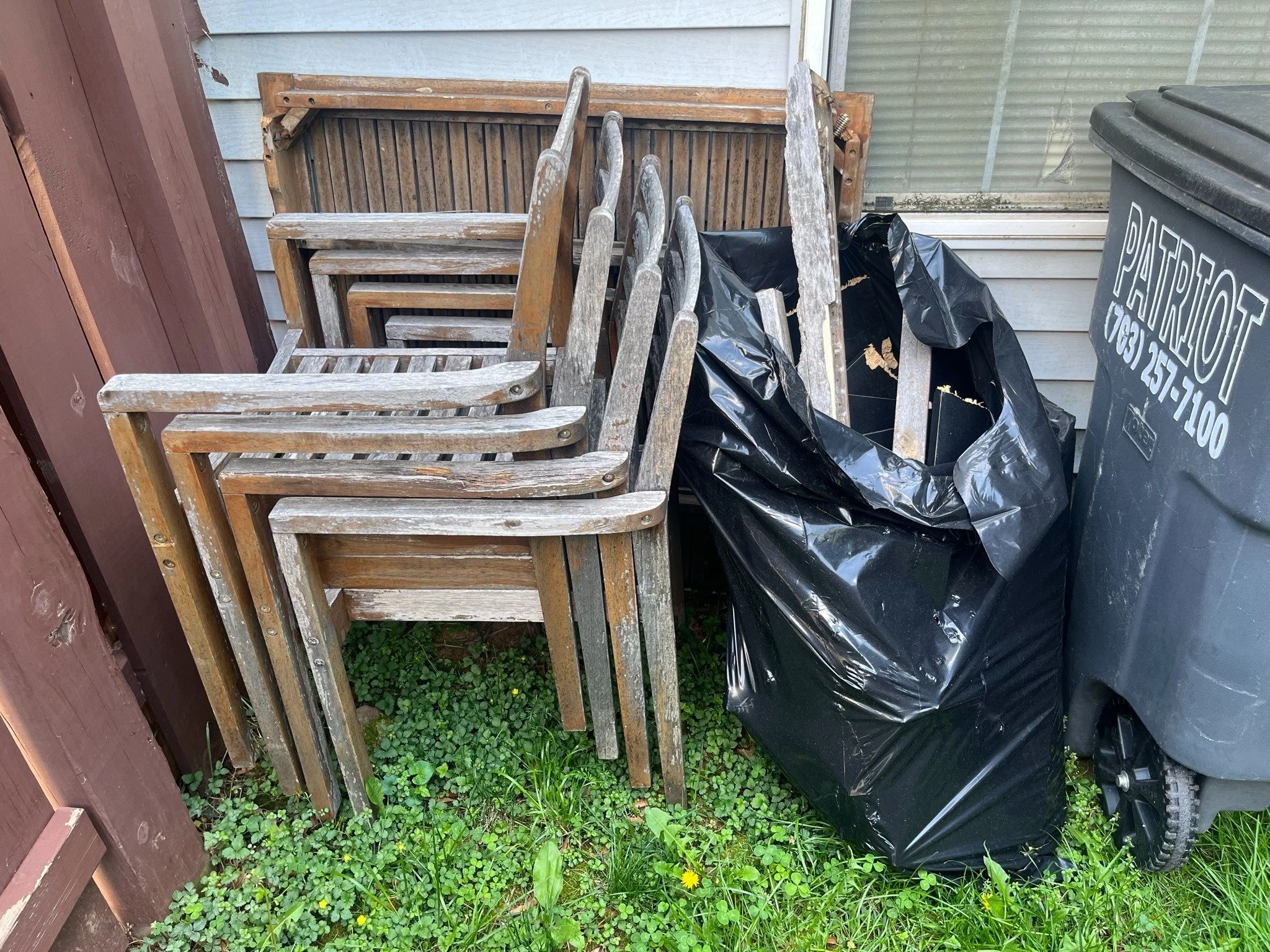Ashburn move cleanout — weathered patio chairs awaiting removal.