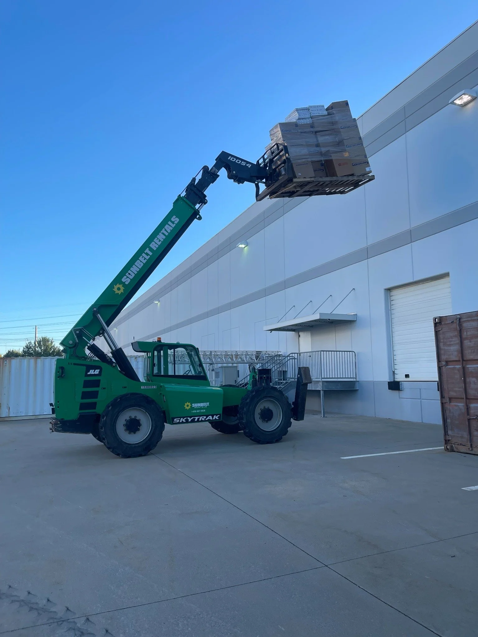 Commercial HVAC filter replacement — lifting boxed filters for rooftop delivery.