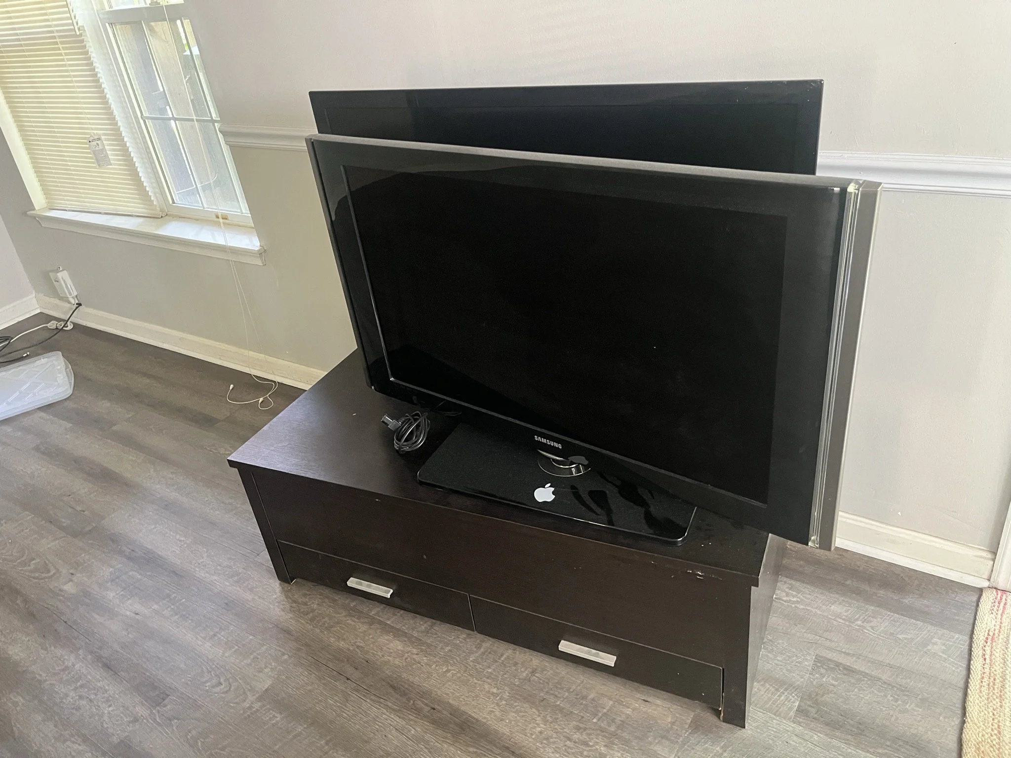 Ashburn move cleanout and donations — televisions and media cabinet.