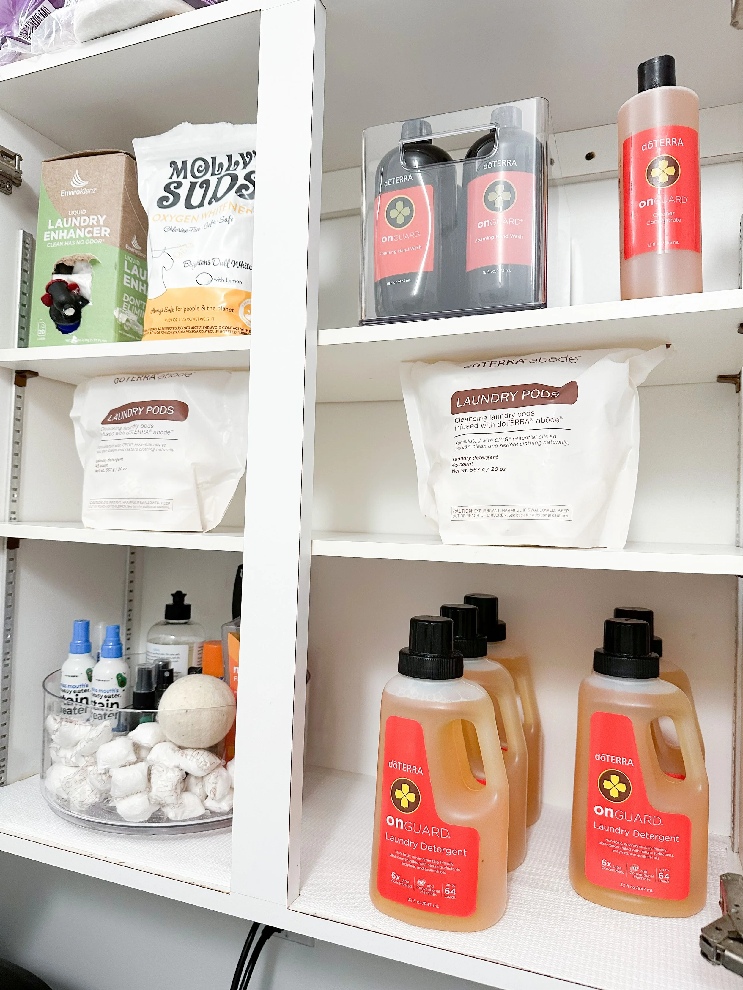 Shelves containing laundry detergent bottles, laundry pods, hand wash, and various laundry-related products.