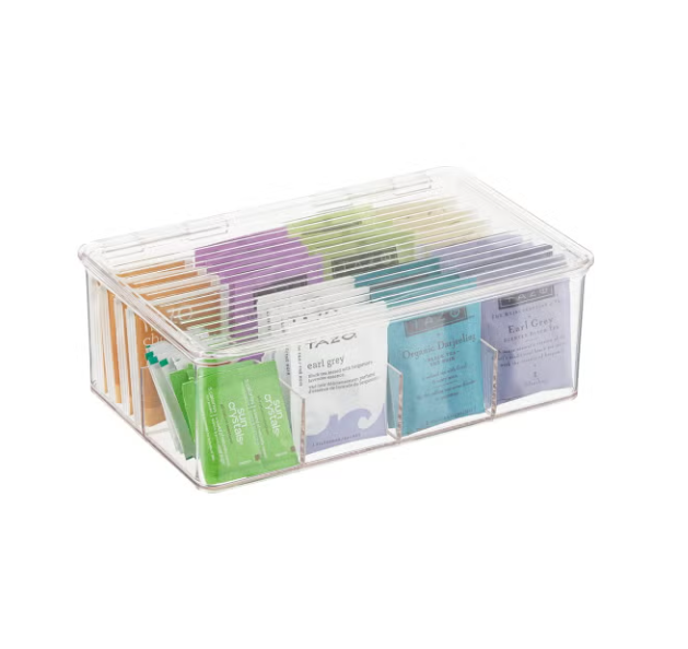 A clear plastic organizer box containing various colorful tea bags.