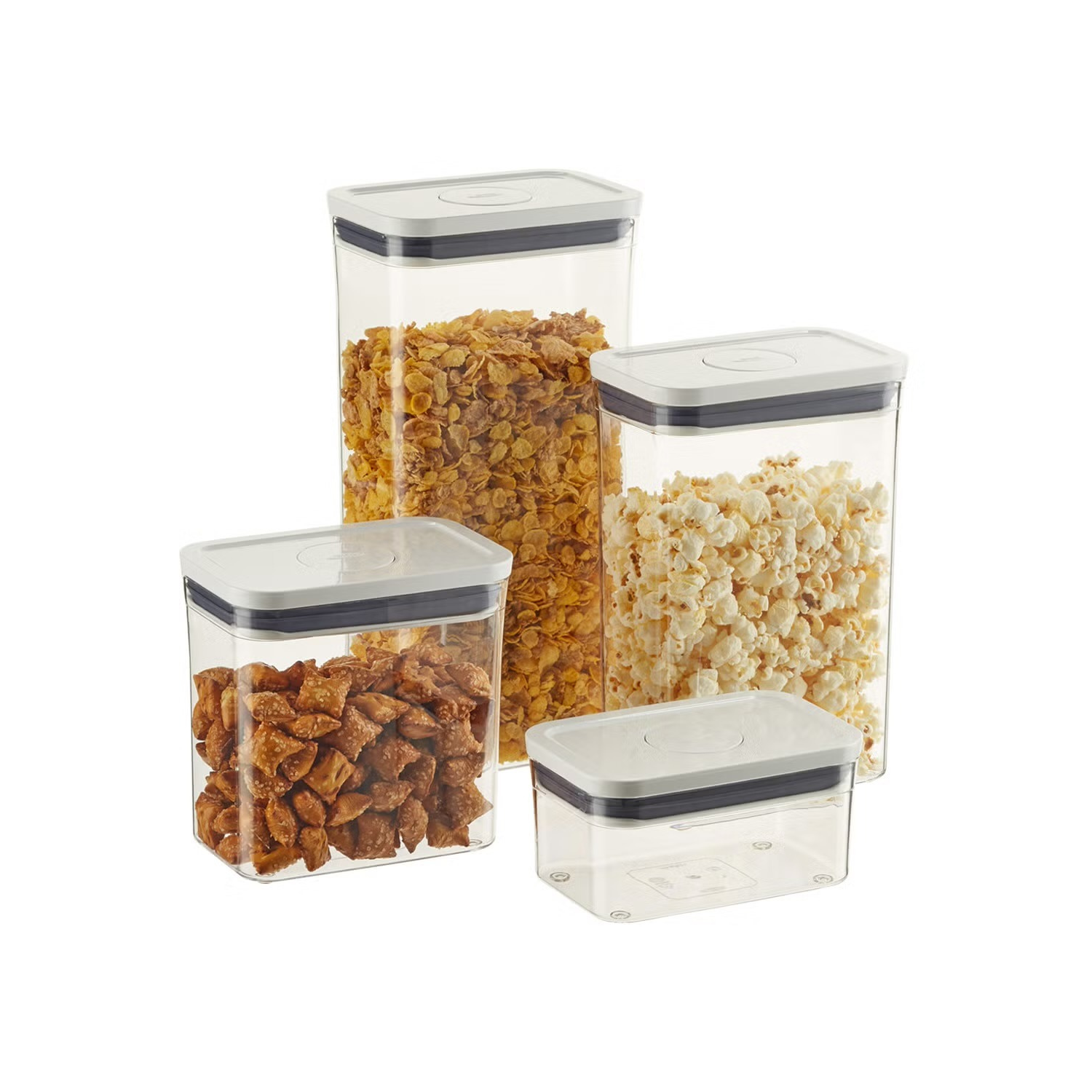 Four clear plastic storage containers with white lids, filled with cereal and popcorn, arranged on a white background.