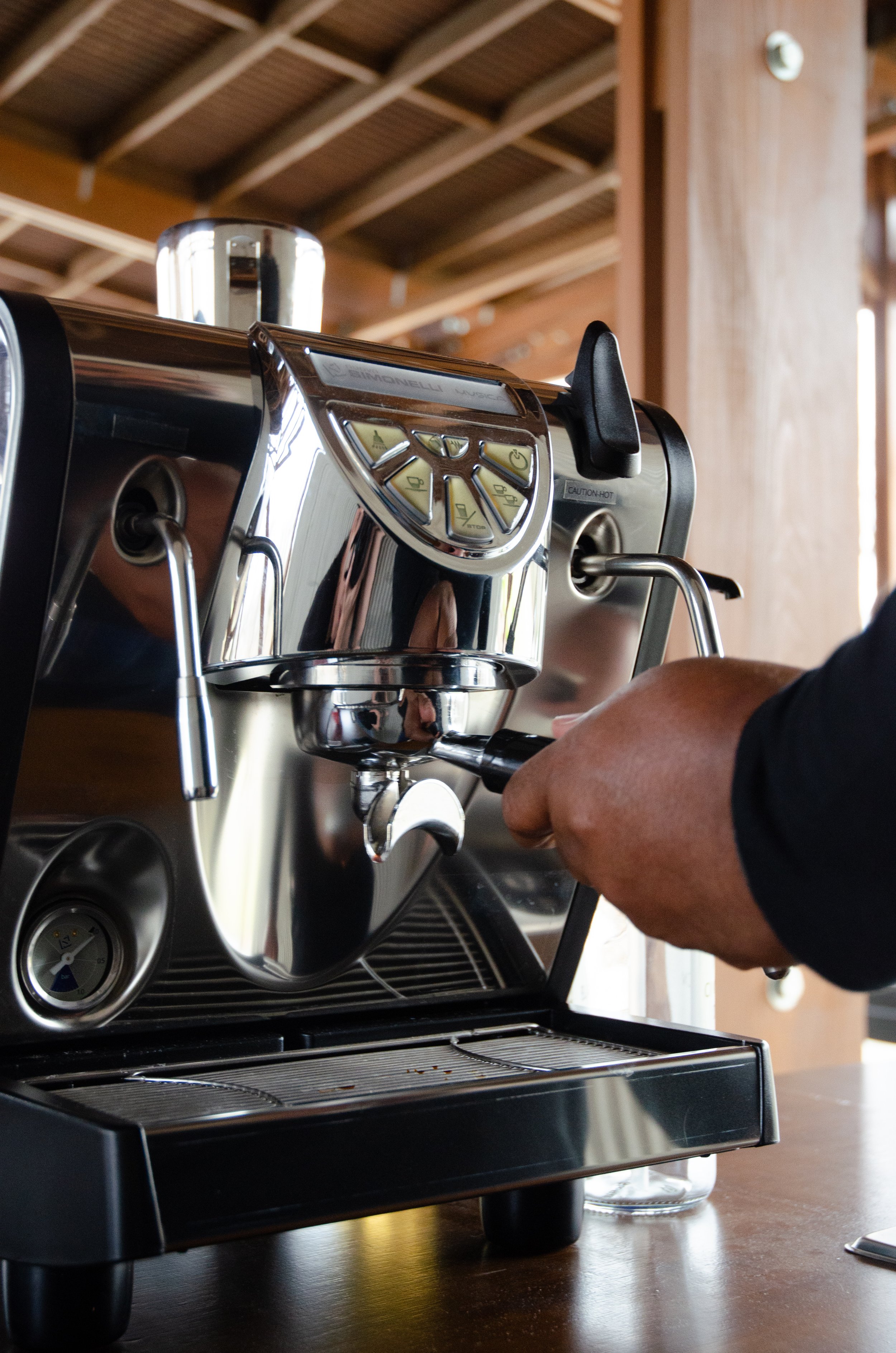 Close-up of a barista making espresso with a professional espresso machine in a cafe. mobile coffee catering