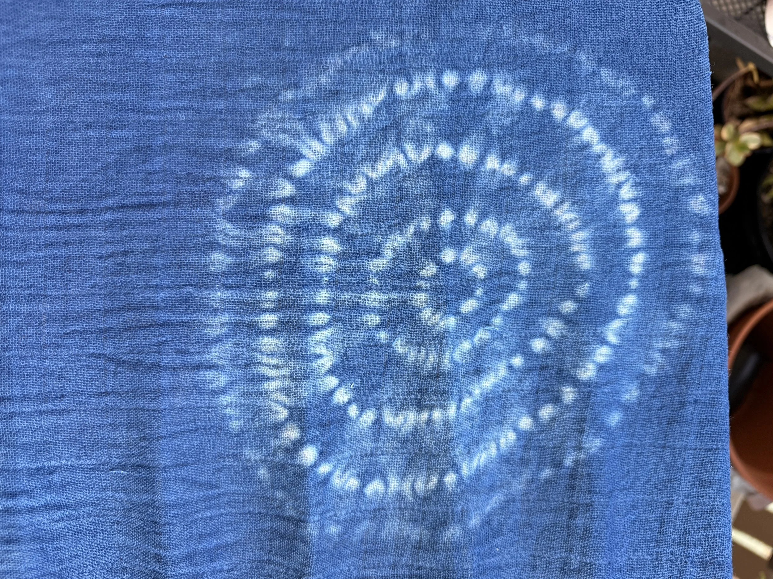 A closer look at one of the larger circles, with five lines of stitching.  The resist circles are distinct and appear more like a bullseye pattern than the traditional larch shibori pattern.