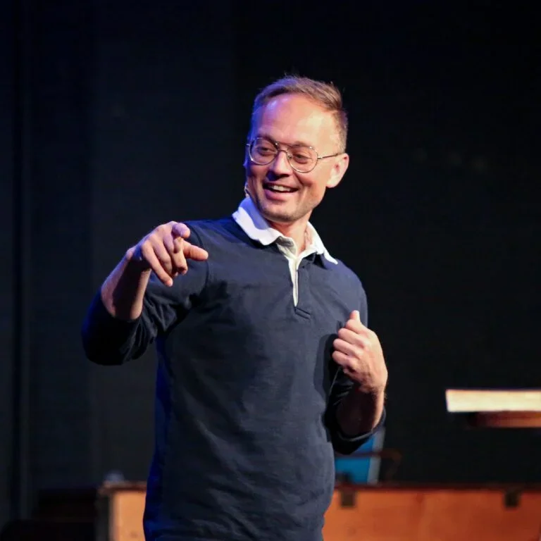 Pastor Josh Miller preaching from stage