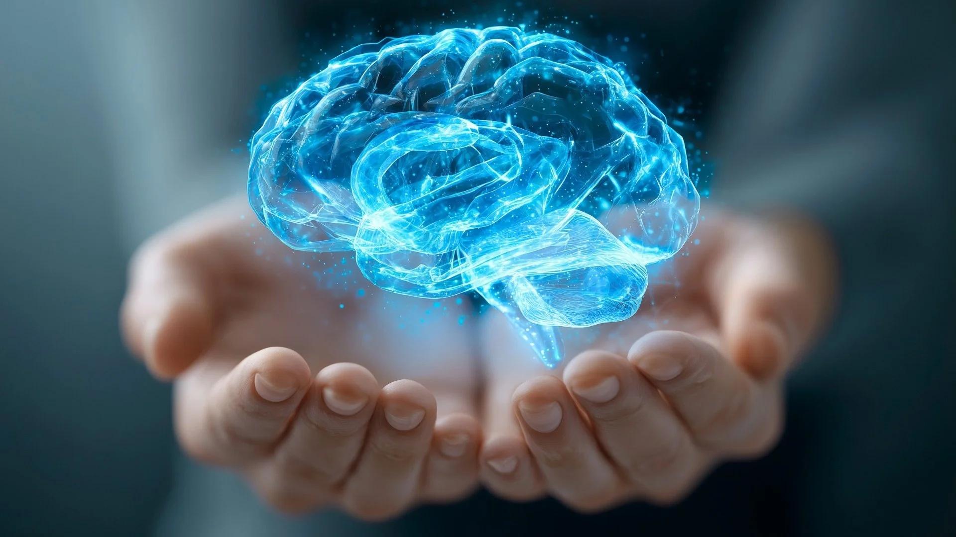 A person's hand holding a glowing, digital blue brain hologram.