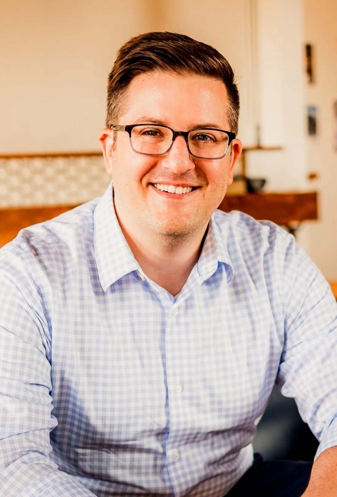Joe Burke, Charlotte-based therapist, sitting indoors with a blurred background.