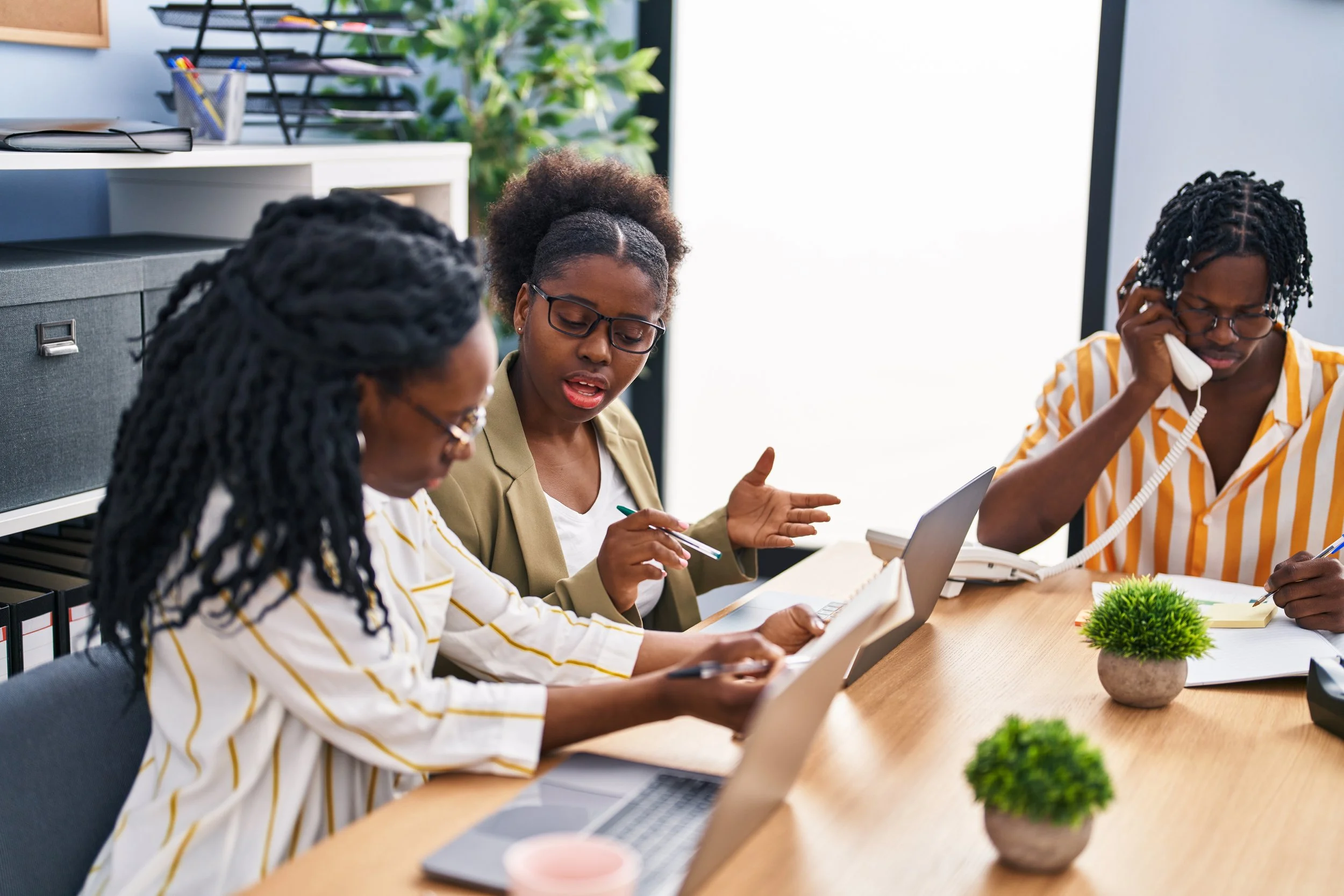 african-american-friends-business-workers-sitting-table-working-office
