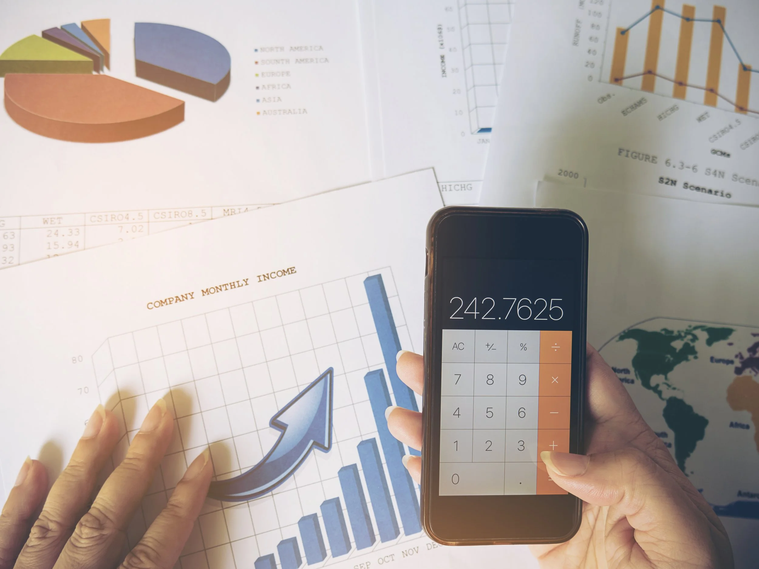 lady-is-using-mobile-telephone-with-her-business-report-document