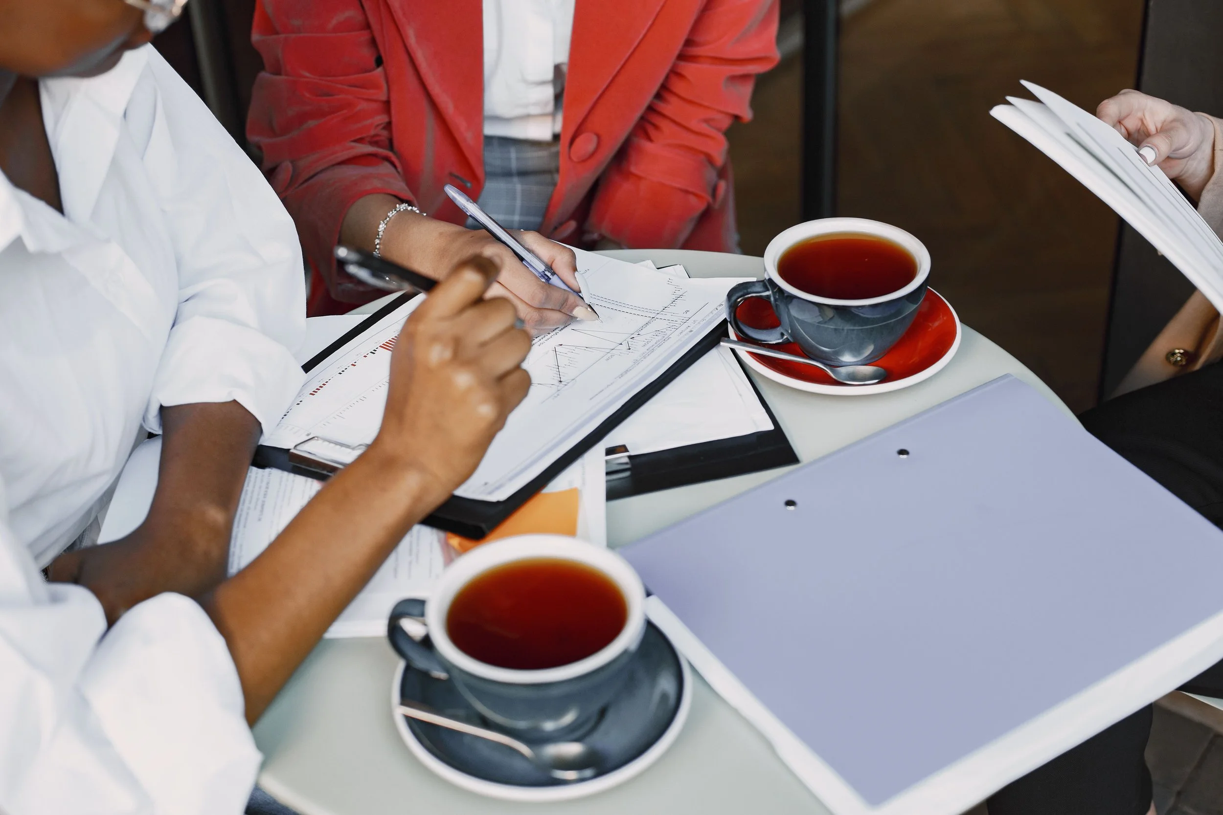 two-women-collaborating-while-drinking-coffee