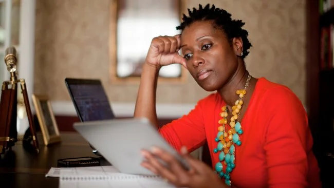 black-woman-viewing-tablet-at-desk