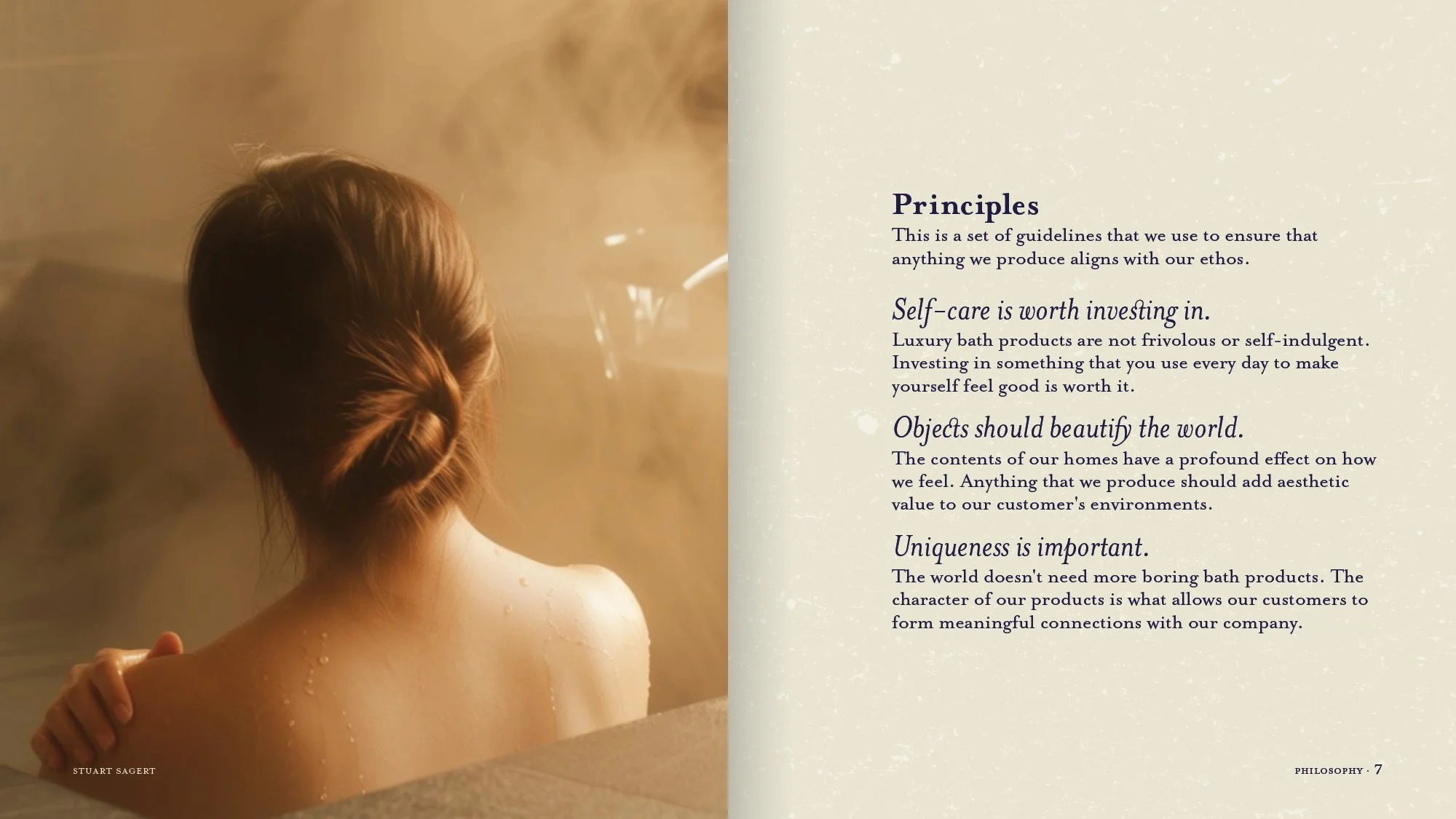 A woman with braided hair taking a bath in a steam-filled tub with water droplets on her shoulder, sitting in a relaxing setting.