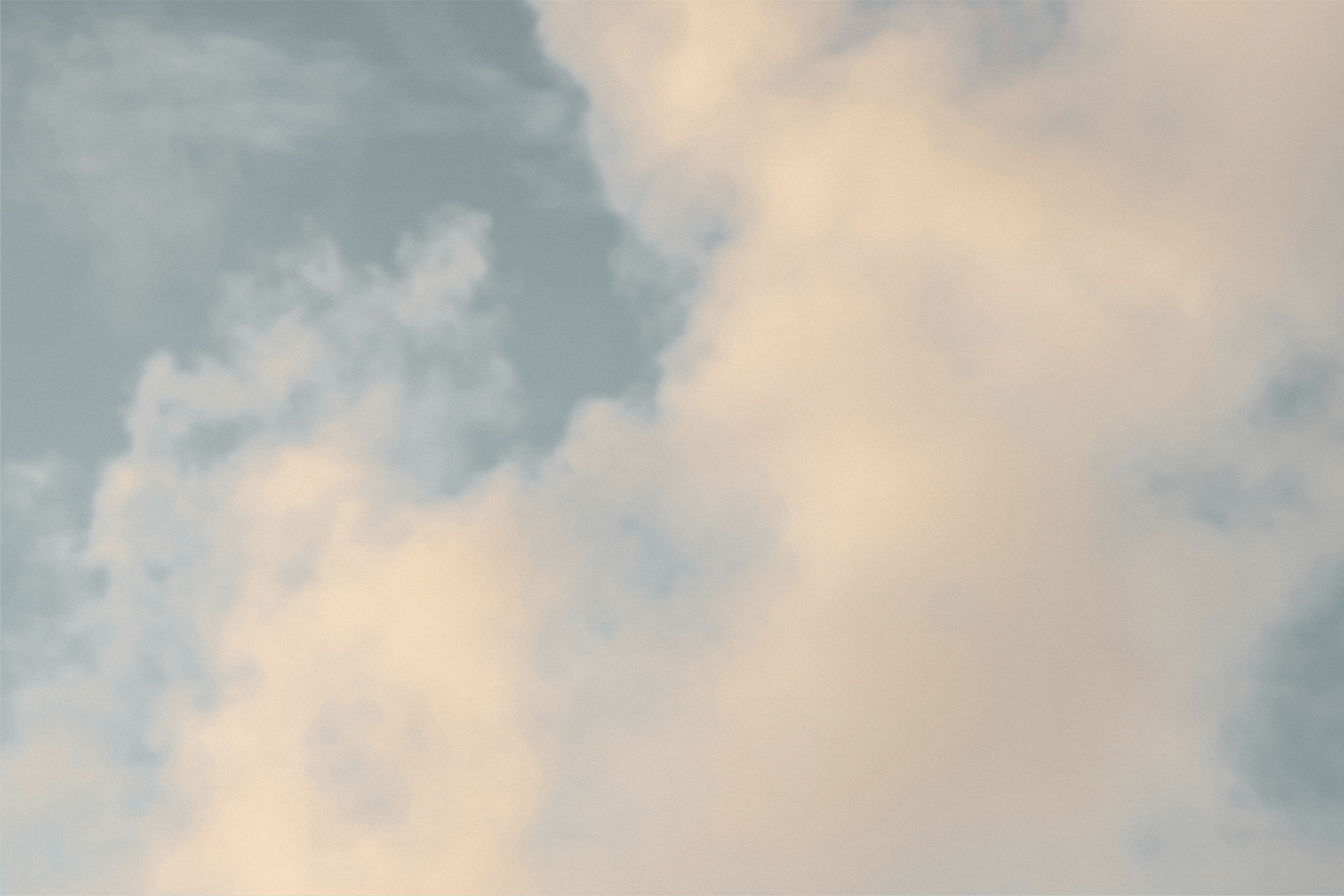 Cloudy sky with a mix of dark and light clouds during daytime.
