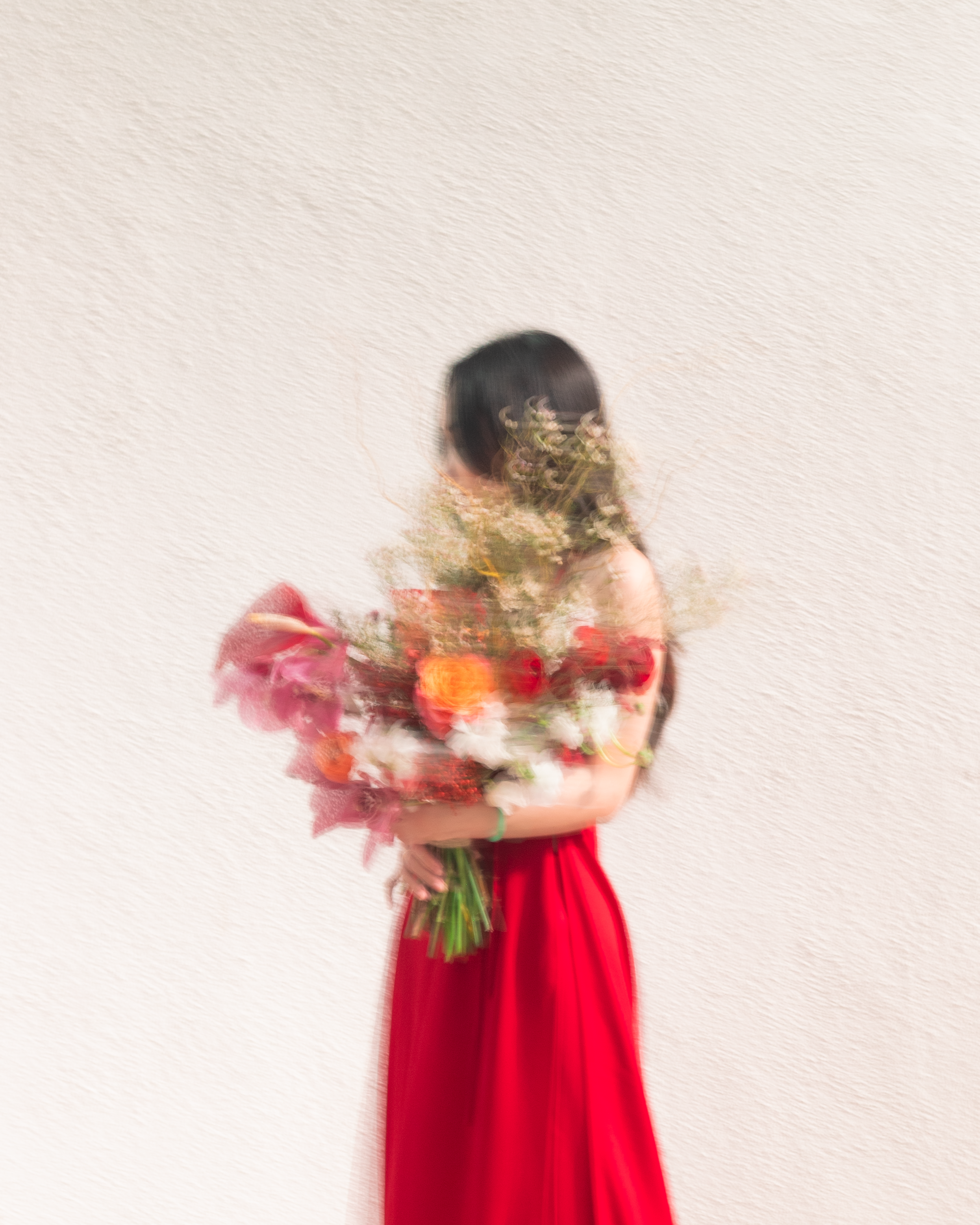 Artistically blurry  photo of Eunoia Blooms founder holding a bouquet of flowers from Lunar New Year.
