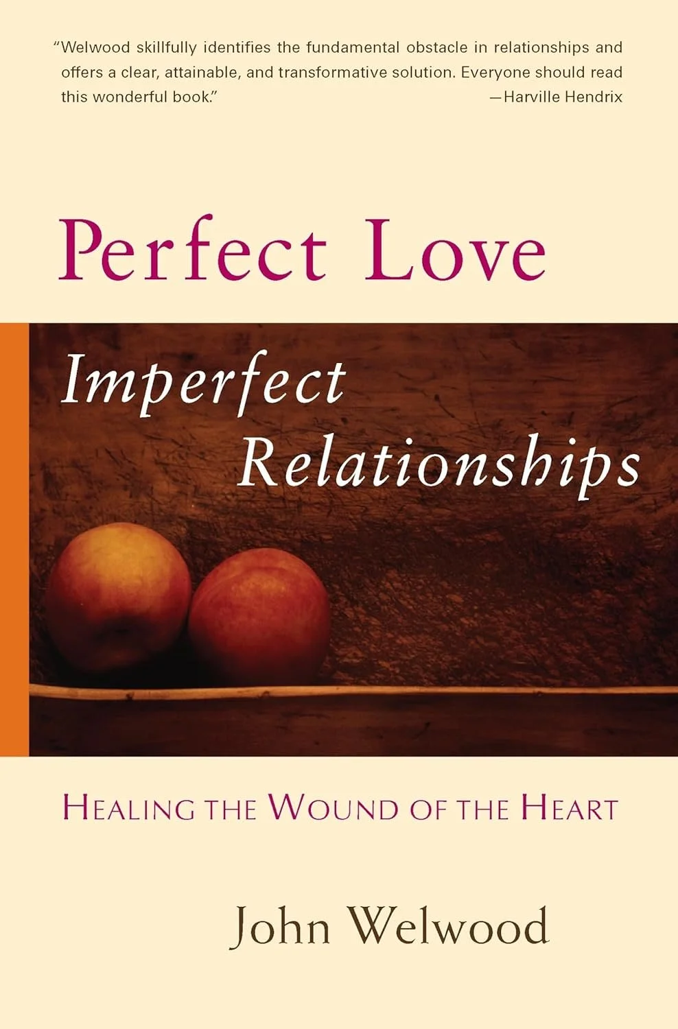 Book cover titled "Perfect Love, Imperfect Relationships" by John Welwood, featuring a wooden surface with two apples and a quote praising the book at the top.