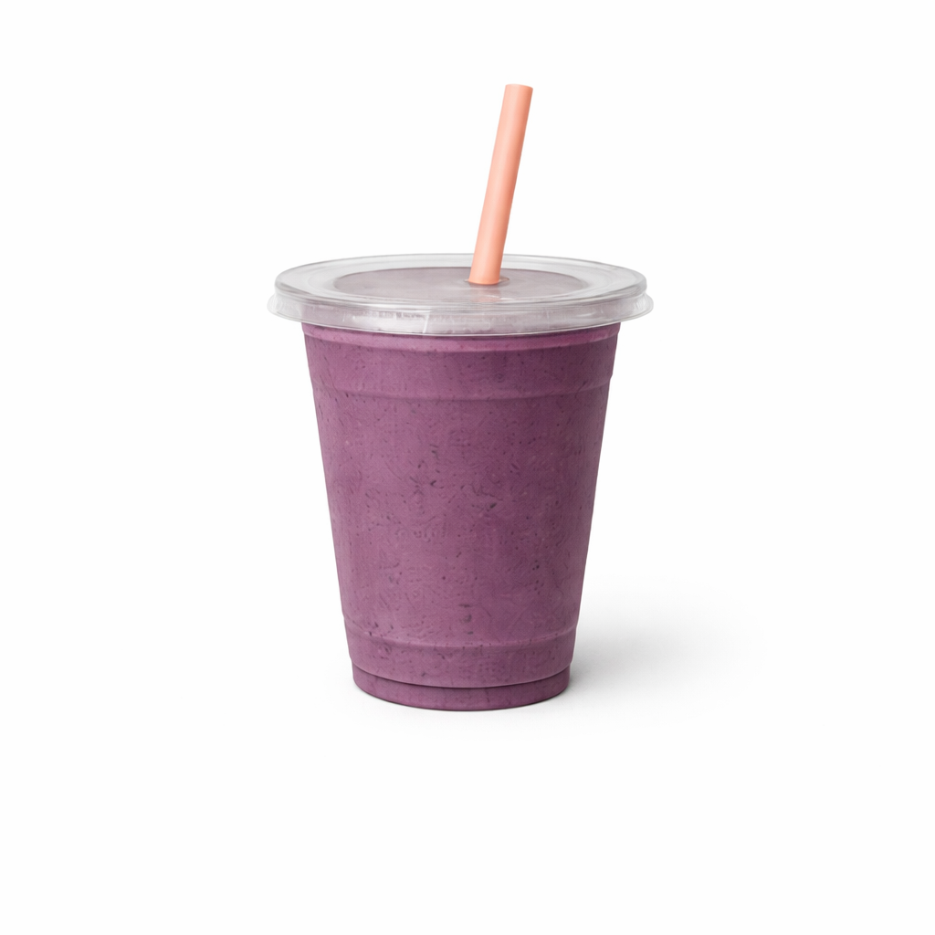 A purple smoothie in a clear cup with a pink straw and a clear plastic lid