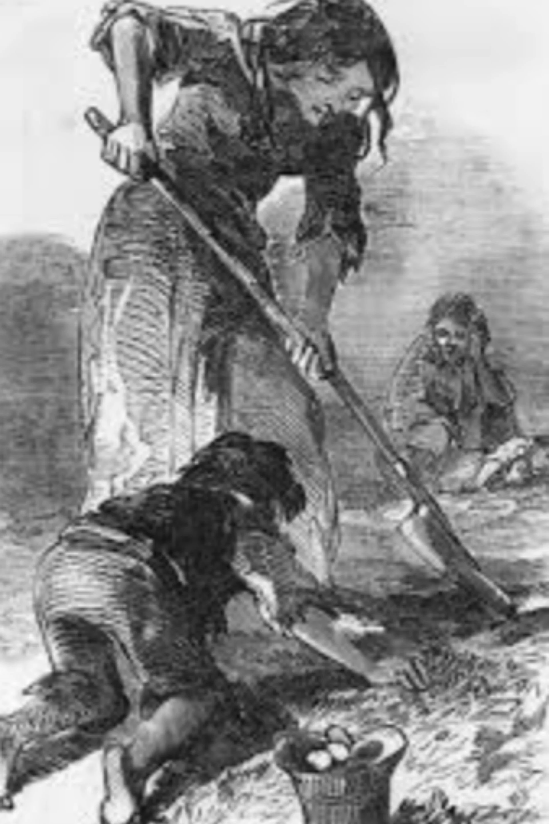 A black and white photograph of two young children playing outside with a dog. One child is leaning forward, holding a stick, and the dog is on the ground nearby. The other child is sitting in the background.