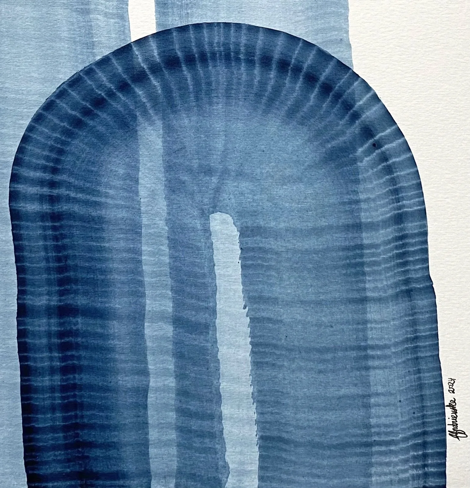 An indigo blue watercolor arch, blue fan with an arched shape, painted on a light-colored paper or surface.